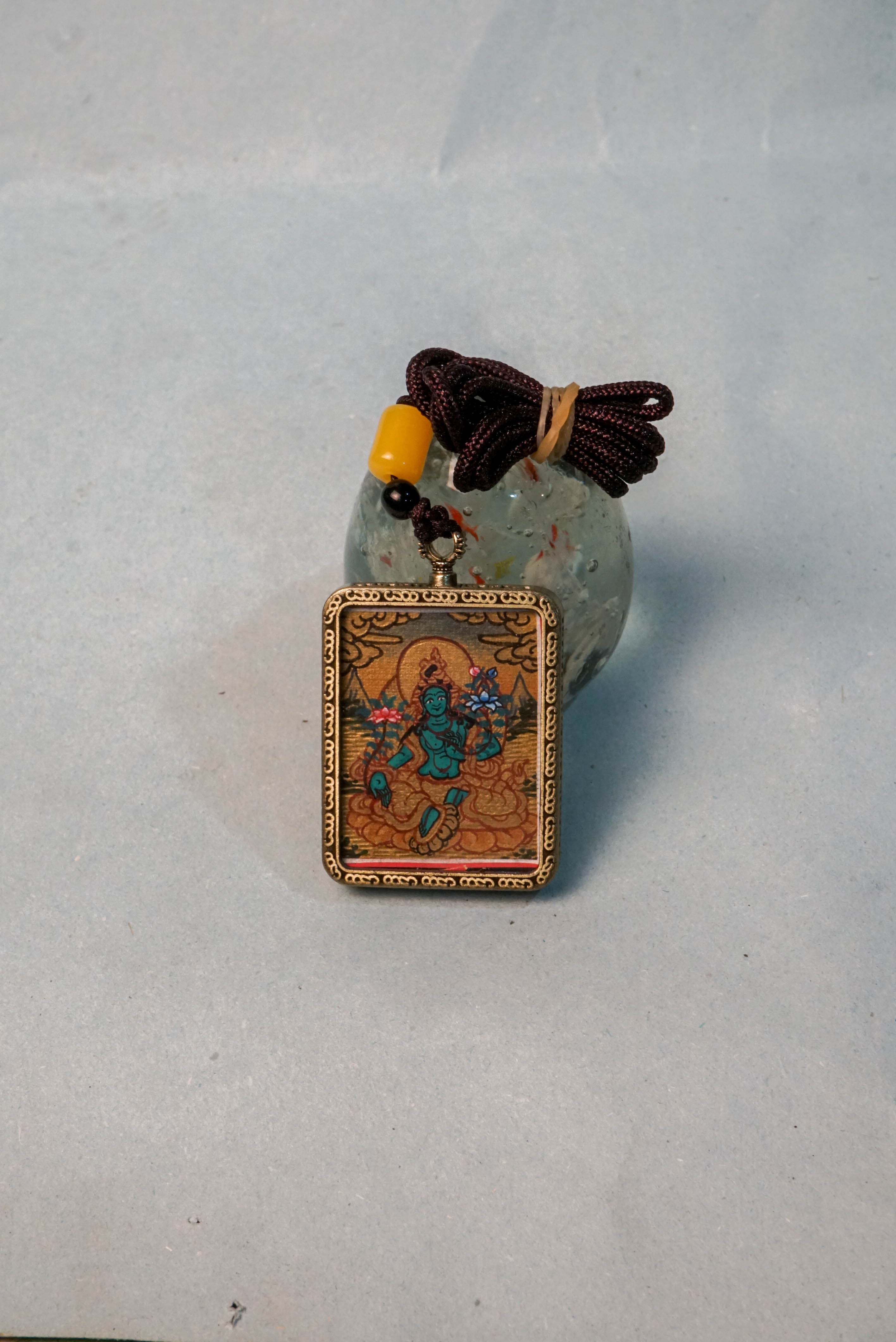 The Green Tara Ghau Thangka is a hand-painted spiritual artwork that embodies compassion, healing, and protection through her vibrant green form. Crafted with natural pigments, this portable shrine invites Tara’s blessings wherever it's kept, making it perfect for meditation and sacred display.
