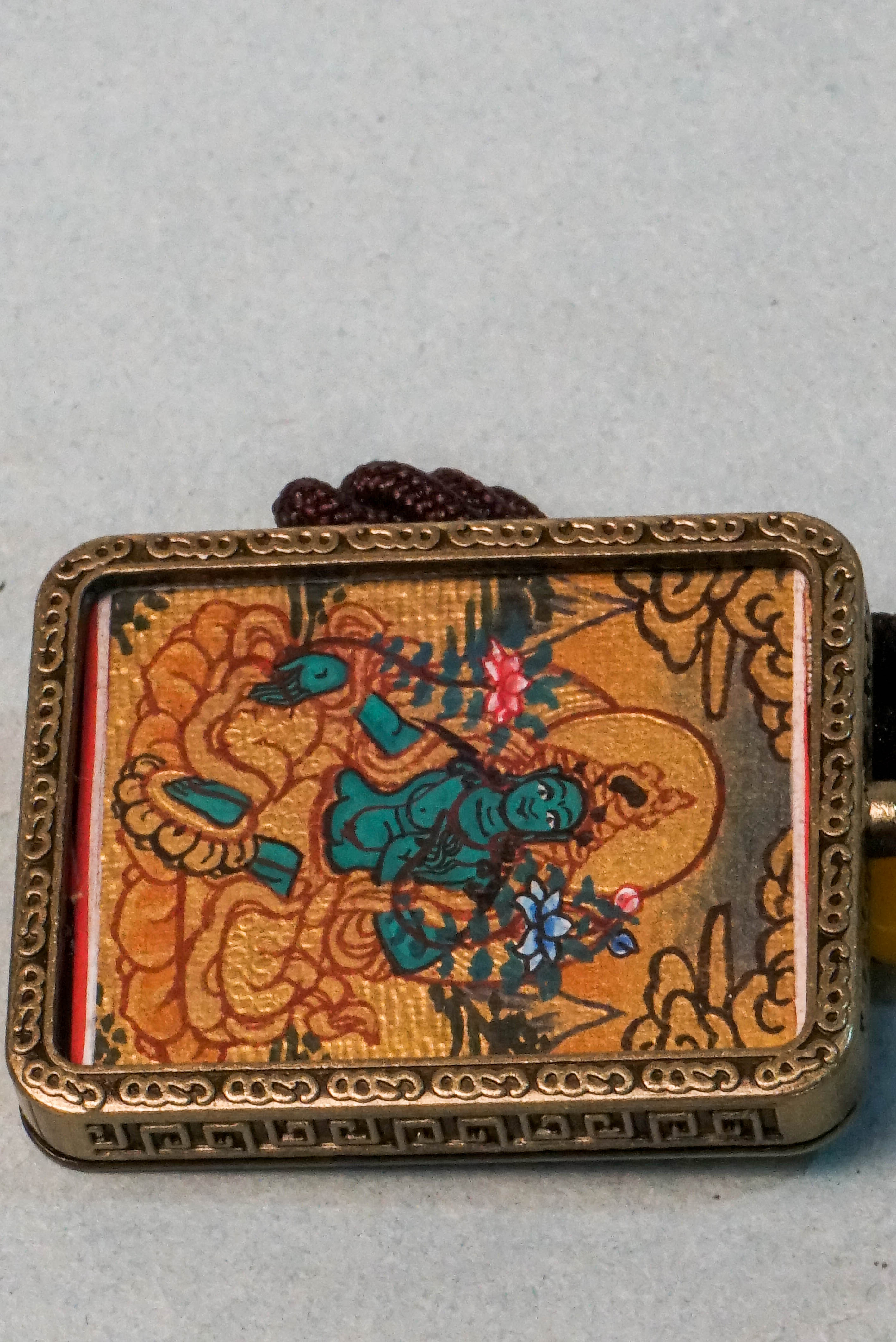 The Green Tara Ghau Thangka is a hand-painted spiritual artwork that embodies compassion, healing, and protection through her vibrant green form. Crafted with natural pigments, this portable shrine invites Tara’s blessings wherever it's kept, making it perfect for meditation and sacred display.