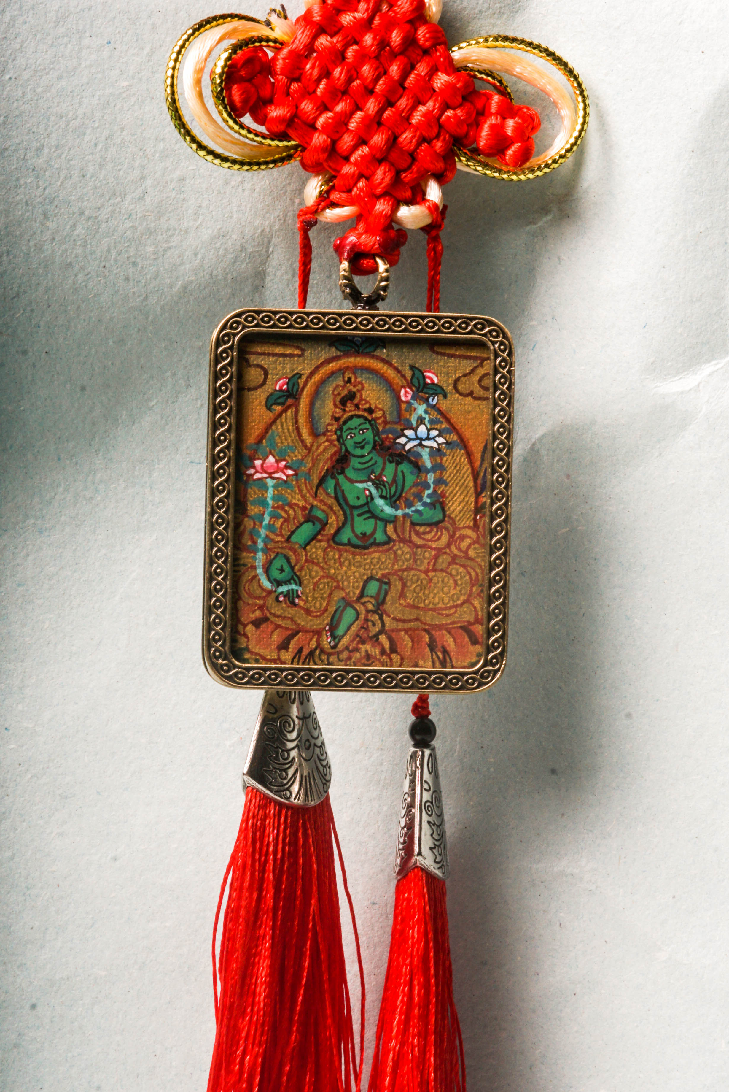 The Green Tara Ghau Thangka is a hand-painted sacred artwork symbolizing compassion, protection, and swift healing. Featuring her vibrant green form and crafted with natural pigments, it serves as a portable shrine to invite Tara’s blessings and grace into your space.