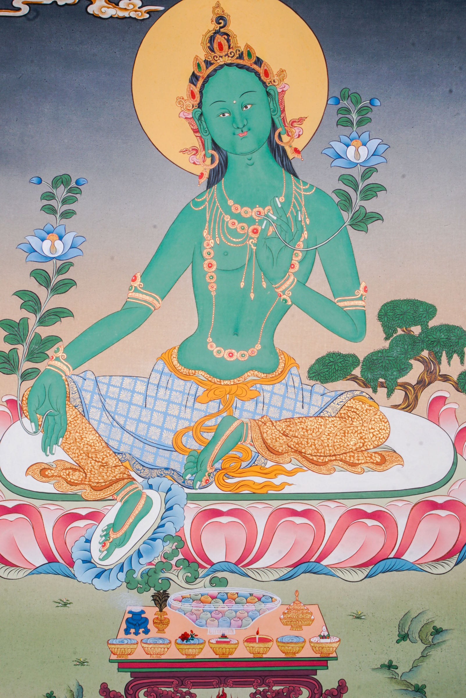 Green Tara Thangka is a Tibetan Buddhist artwork of the goddess of compassion and protection. Her green form symbolizes swift action, healing, and the removal of obstacles. 