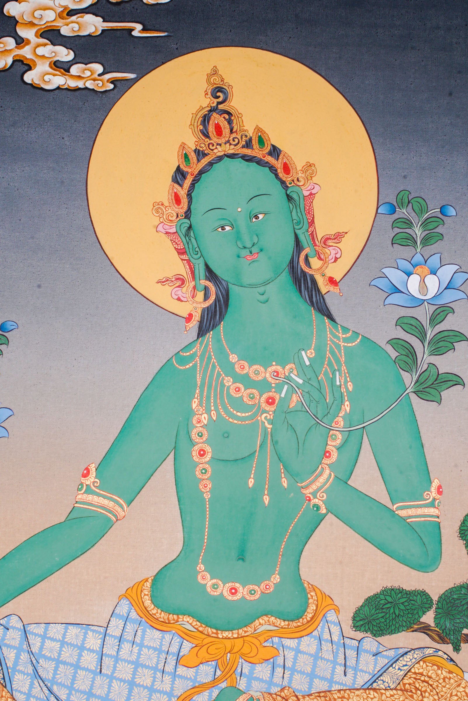 Green Tara Thangka is a Tibetan Buddhist artwork of the goddess of compassion and protection. Her green form symbolizes swift action, healing, and the removal of obstacles. 