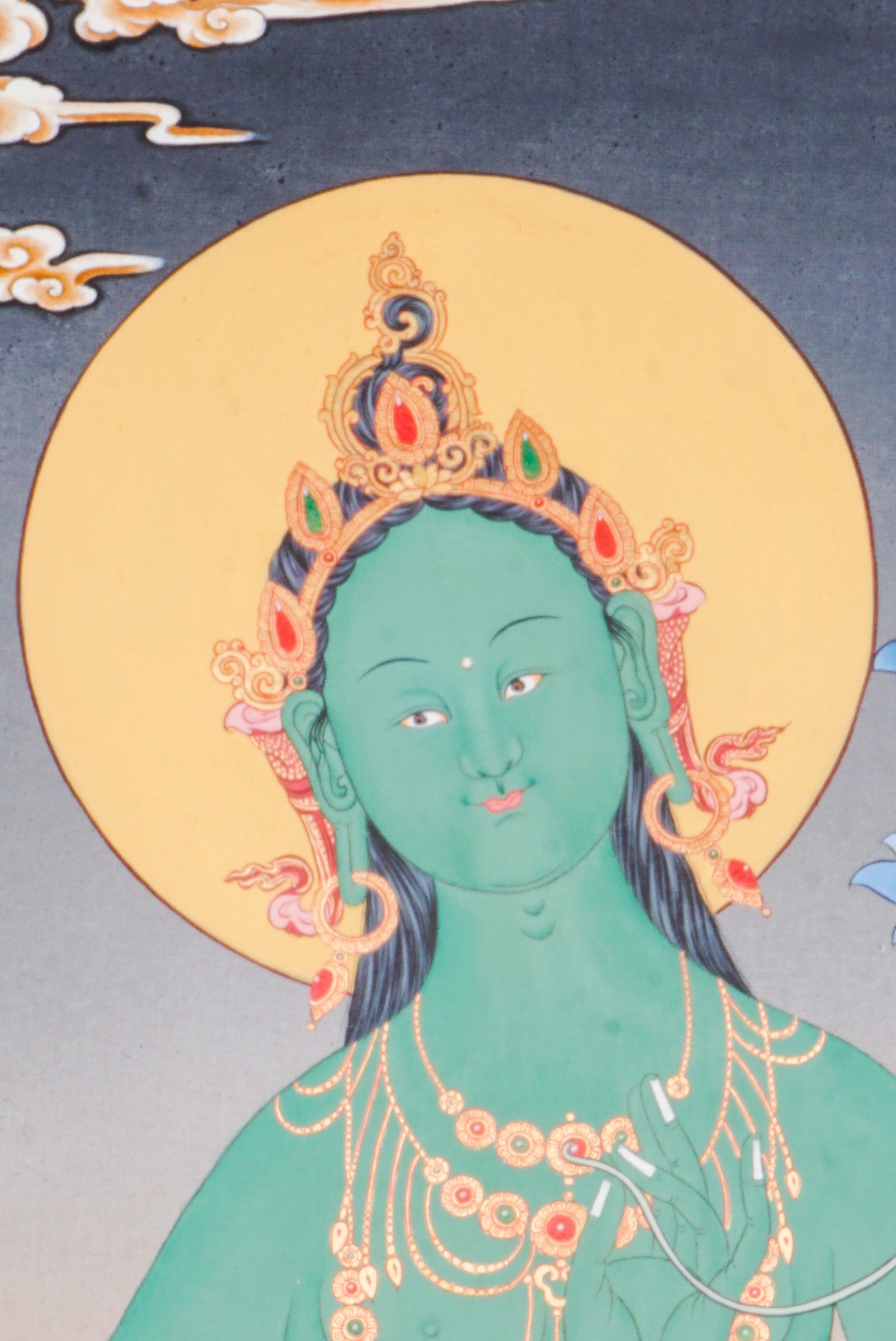 Green Tara Thangka is a Tibetan Buddhist artwork of the goddess of compassion and protection. Her green form symbolizes swift action, healing, and the removal of obstacles. 