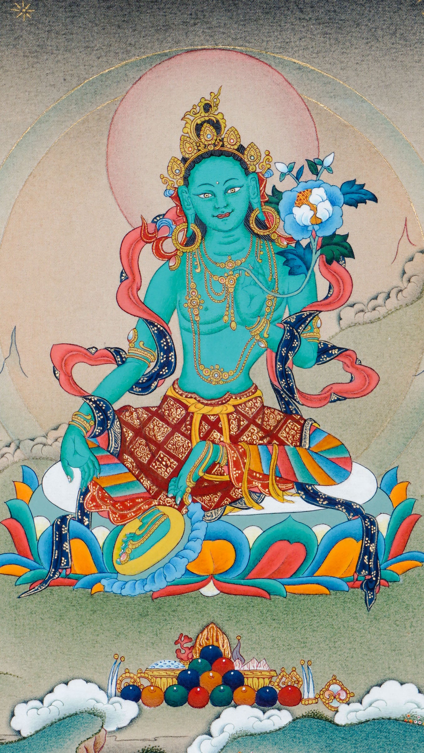 Tibetan thangka of Green Tara seated in lalitasana on a lotus throne, right hand in varada mudra and left hand holding a blue lotus, surrounded by a serene and peaceful background.