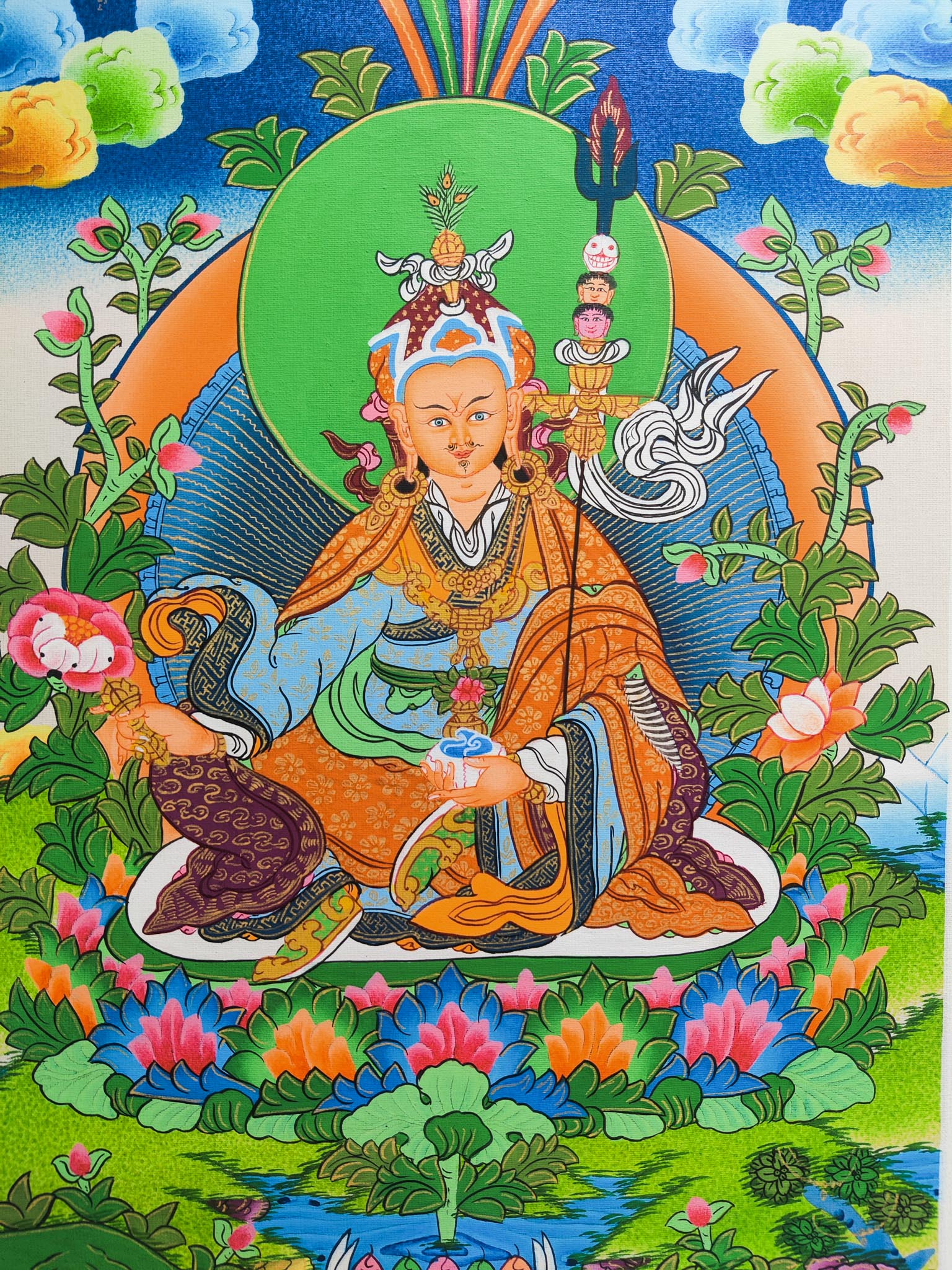 Guru Padmasambhava Thangka is a sacred depiction of a revered figure in Tibetan Buddhism, skillfully crafted by seasoned Tibetan artists using traditional methods