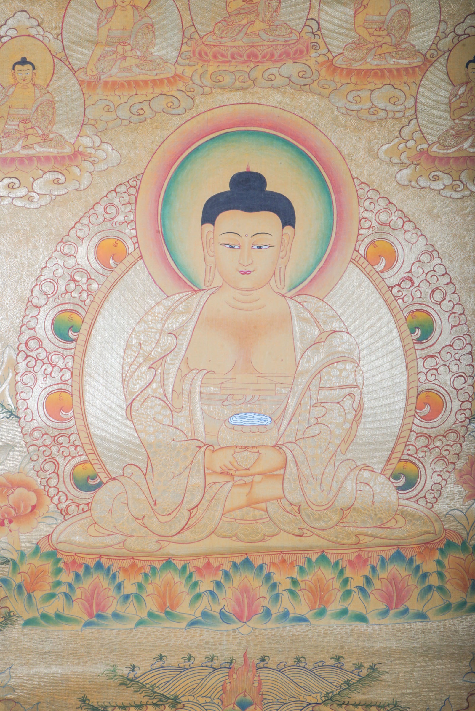Amitabha Buddha on Gold- a depiction of a seated Buddha figure with decorative elements on a textured background