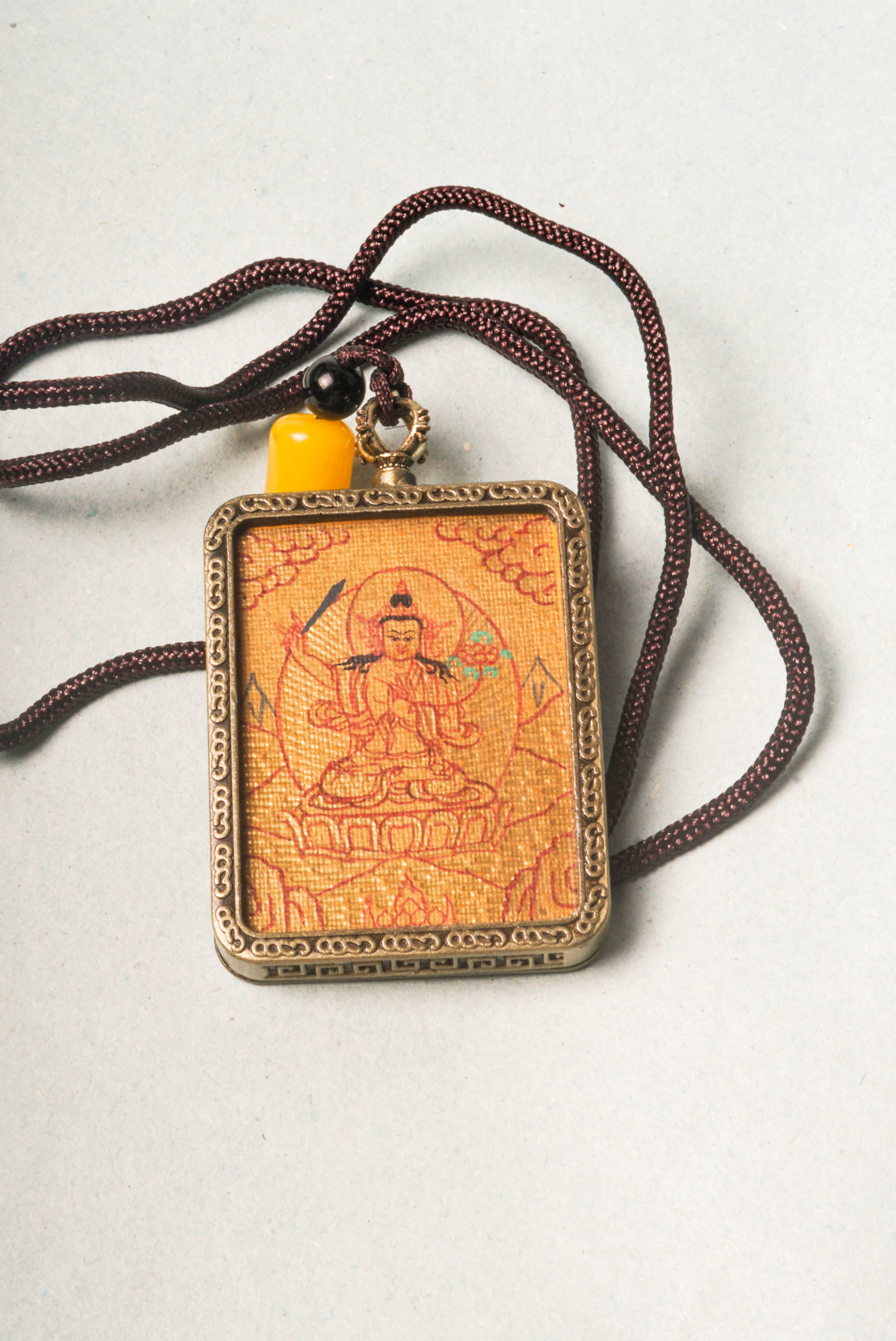 Manjushri, Bodhisattva of wisdom, cuts through ignorance. Our handcrafted Lyap Manjushri Ghau Thangka inspires meditation and spiritual growth.