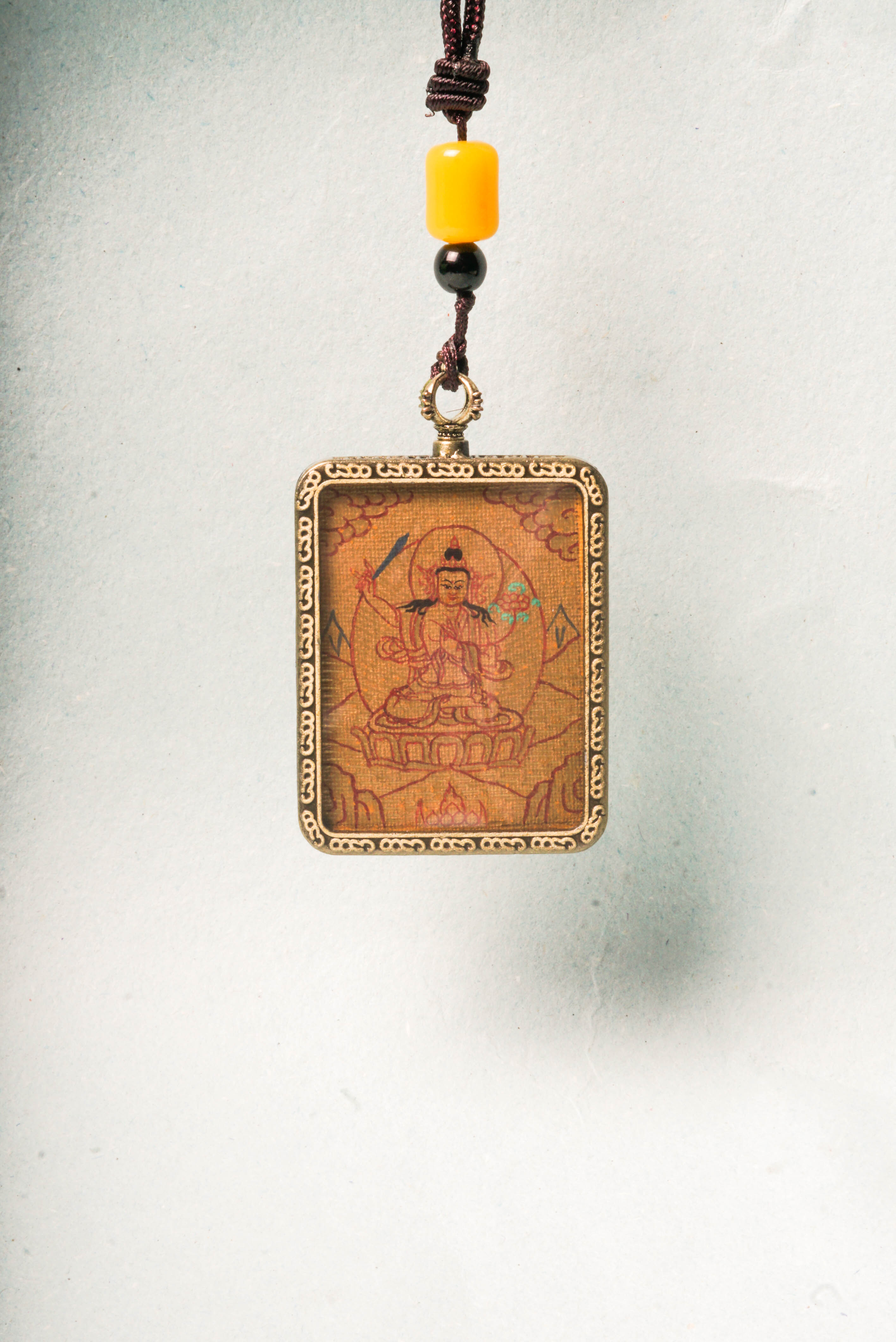 Manjushri, Bodhisattva of wisdom, cuts through ignorance. Our handcrafted Lyap Manjushri Ghau Thangka inspires meditation and spiritual growth.