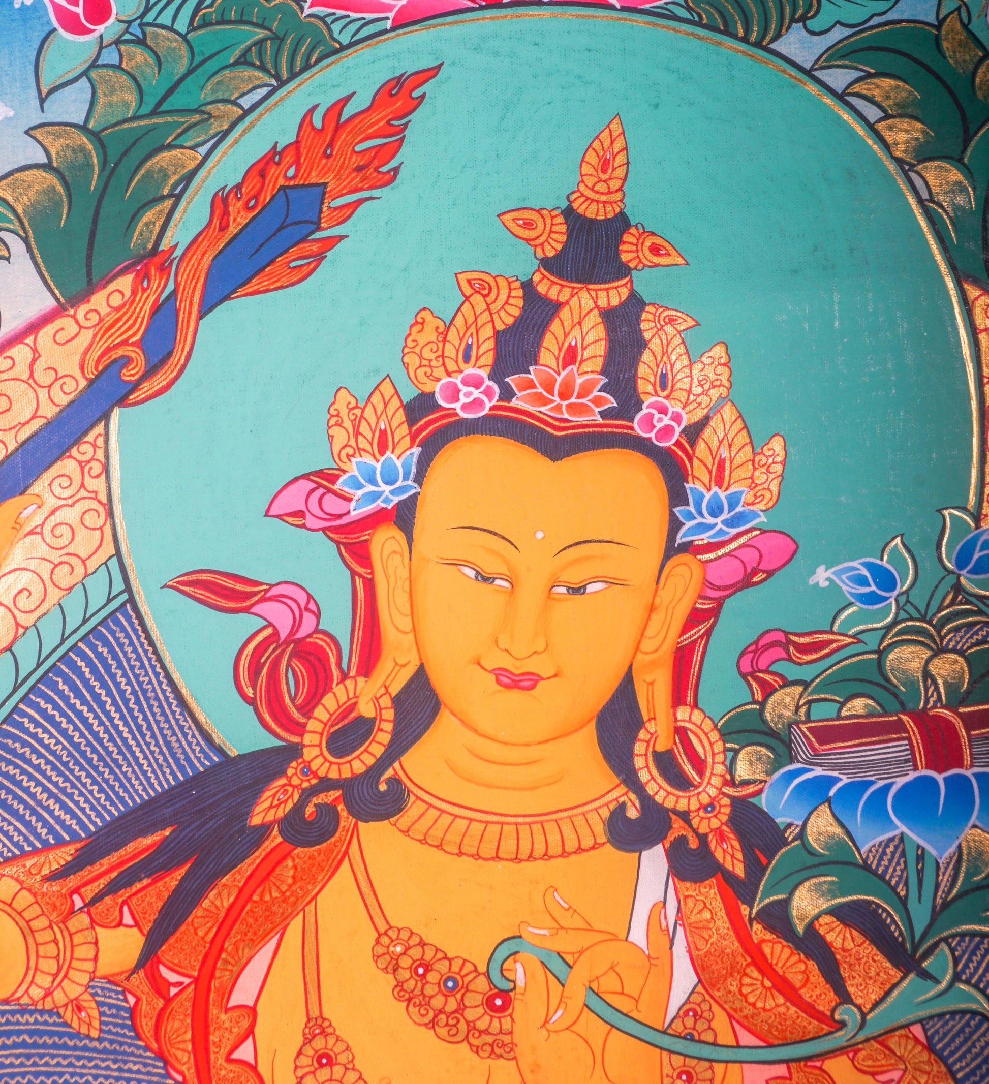 This handmade Manjushri Thangka Painting embodies the divine wisdom and beauty of Manjushri