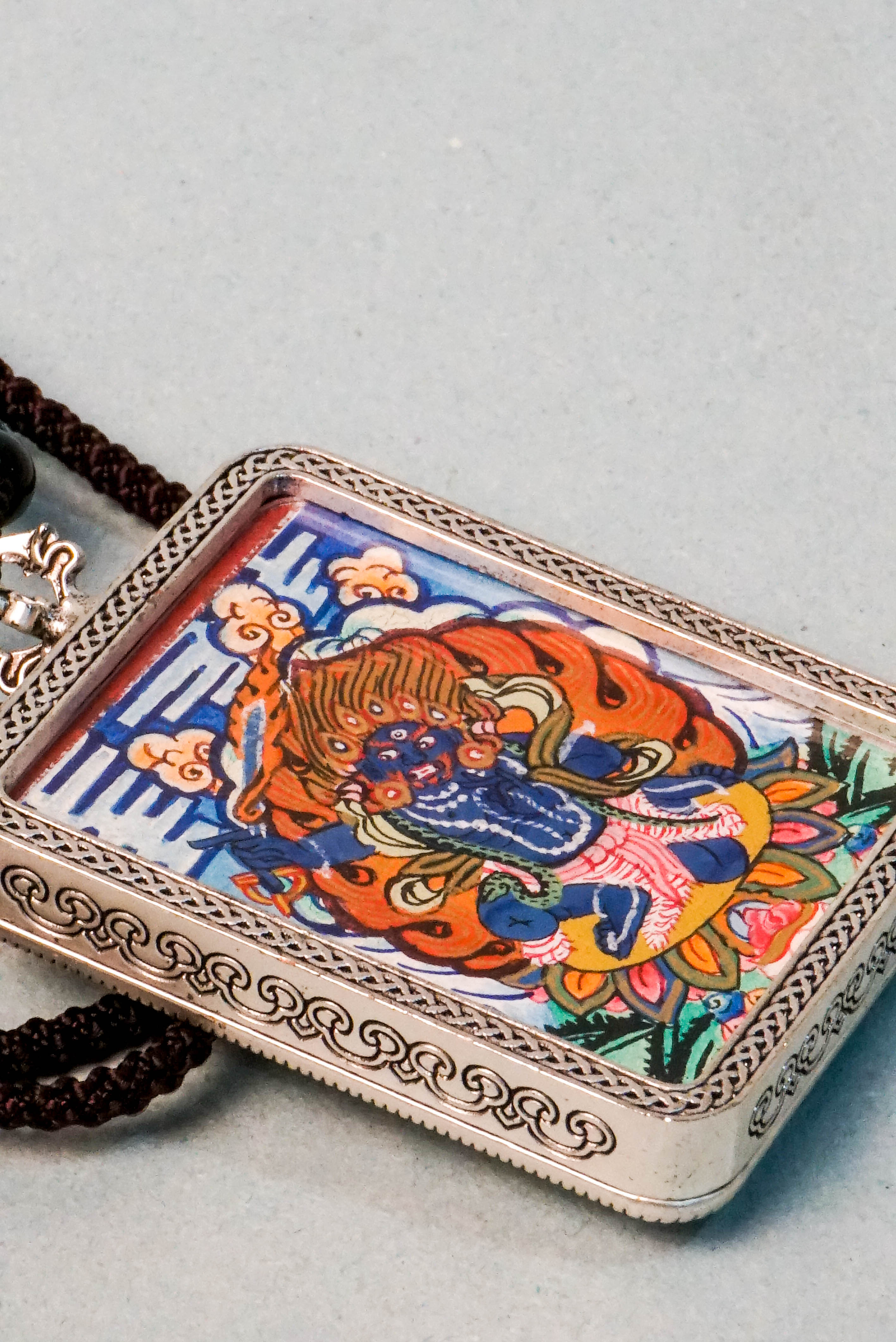 Mahakala is a fierce protector in Tibetan Buddhism, embodying transformative energy that removes obstacles and safeguards spiritual practice. This hand-painted Mahakala Ghau Thangka, crafted with vibrant mineral pigments, serves as a powerful amulet for protection and spiritual growth.