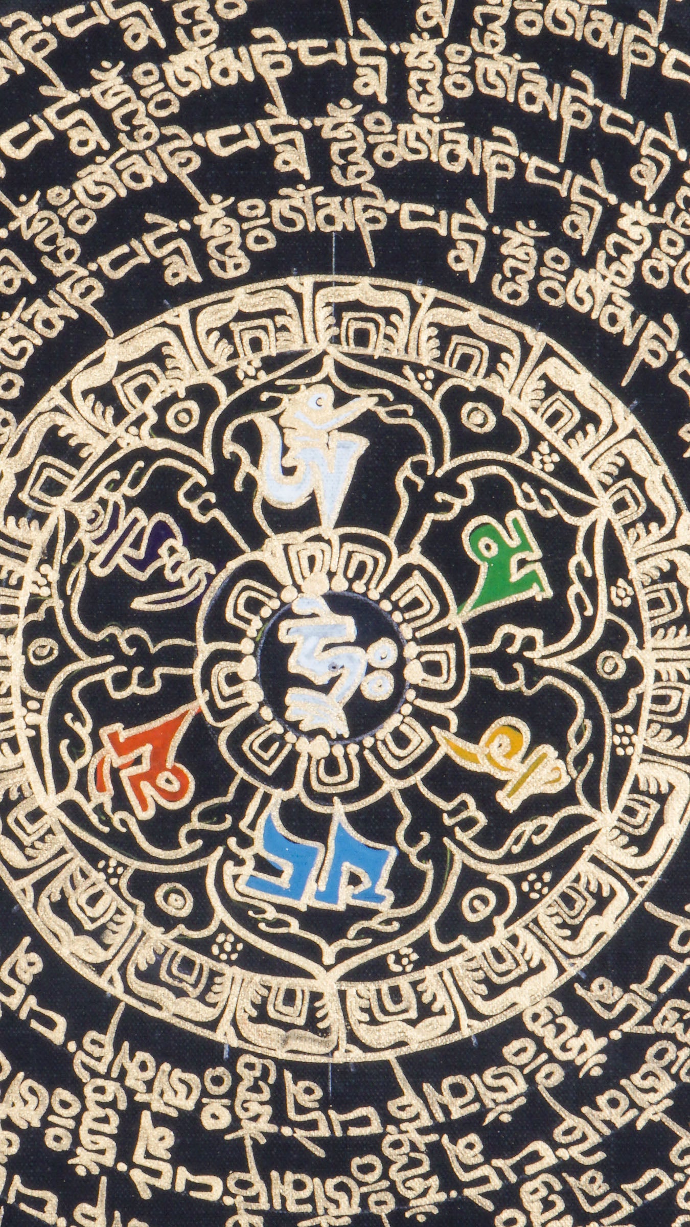 Tibetan mantra mandala thangka with concentric rings of sacred script surrounding a central symbol, framed by dragons and ornate gold detailing on a black background.