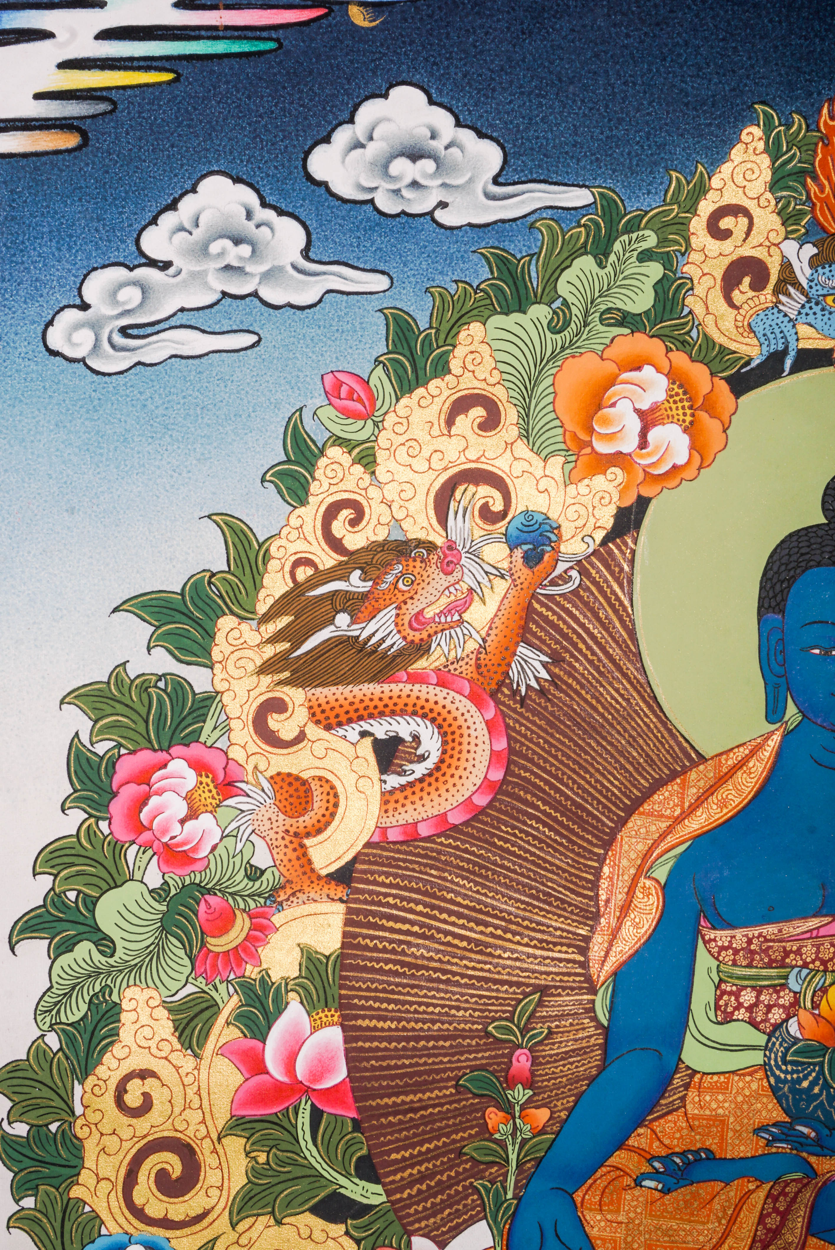 Medicine Buddha Thangka featuring the blue-colored Supreme Healer seated in meditation holding the arura plant and nectar bowl, hand-painted in traditional Tibetan style with rich symbolism of healing, protection, and inner peace. 