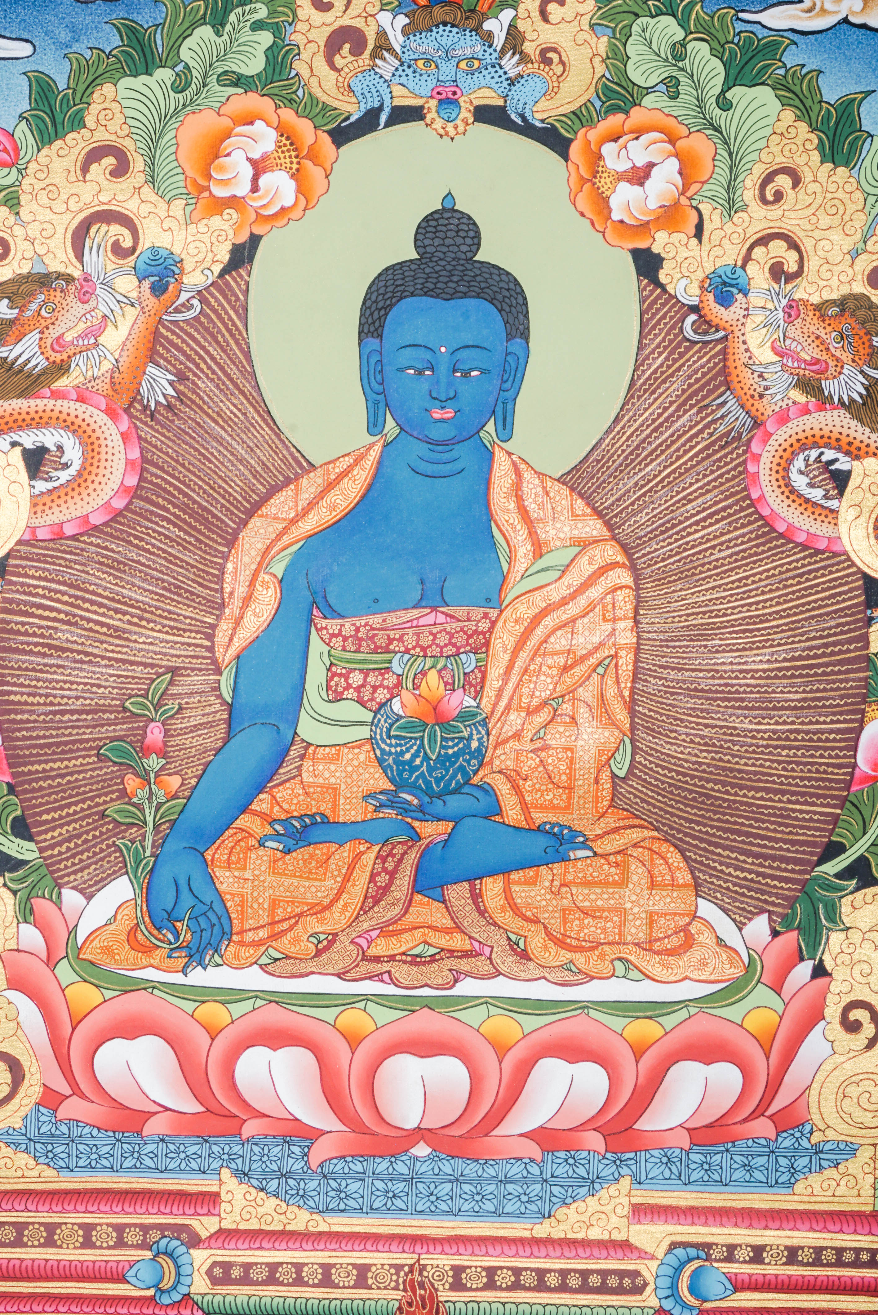 Medicine Buddha Thangka featuring the blue-colored Supreme Healer seated in meditation holding the arura plant and nectar bowl, hand-painted in traditional Tibetan style with rich symbolism of healing, protection, and inner peace. 