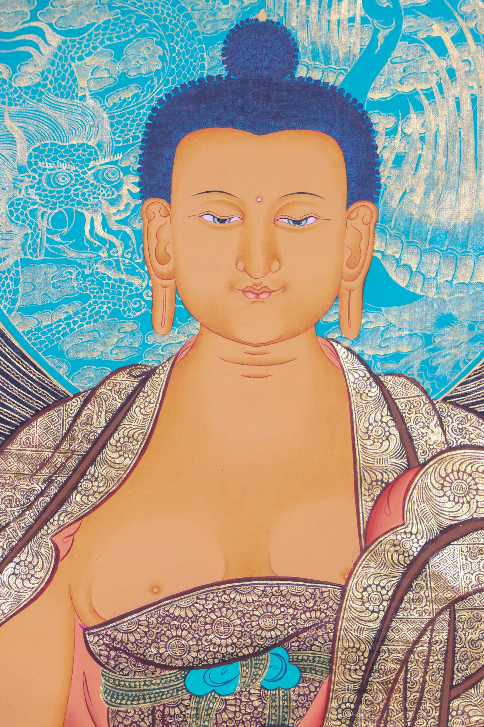 This genuine Tibetan thangka of Shakyamuni Buddha is handcrafted on cotton canvas using mineral pigments, capturing the enlightened essence of the historical Buddha with serene precision. A powerful symbol in Buddhism, it brings spiritual depth and sacred energy to any meditation or devotional space.