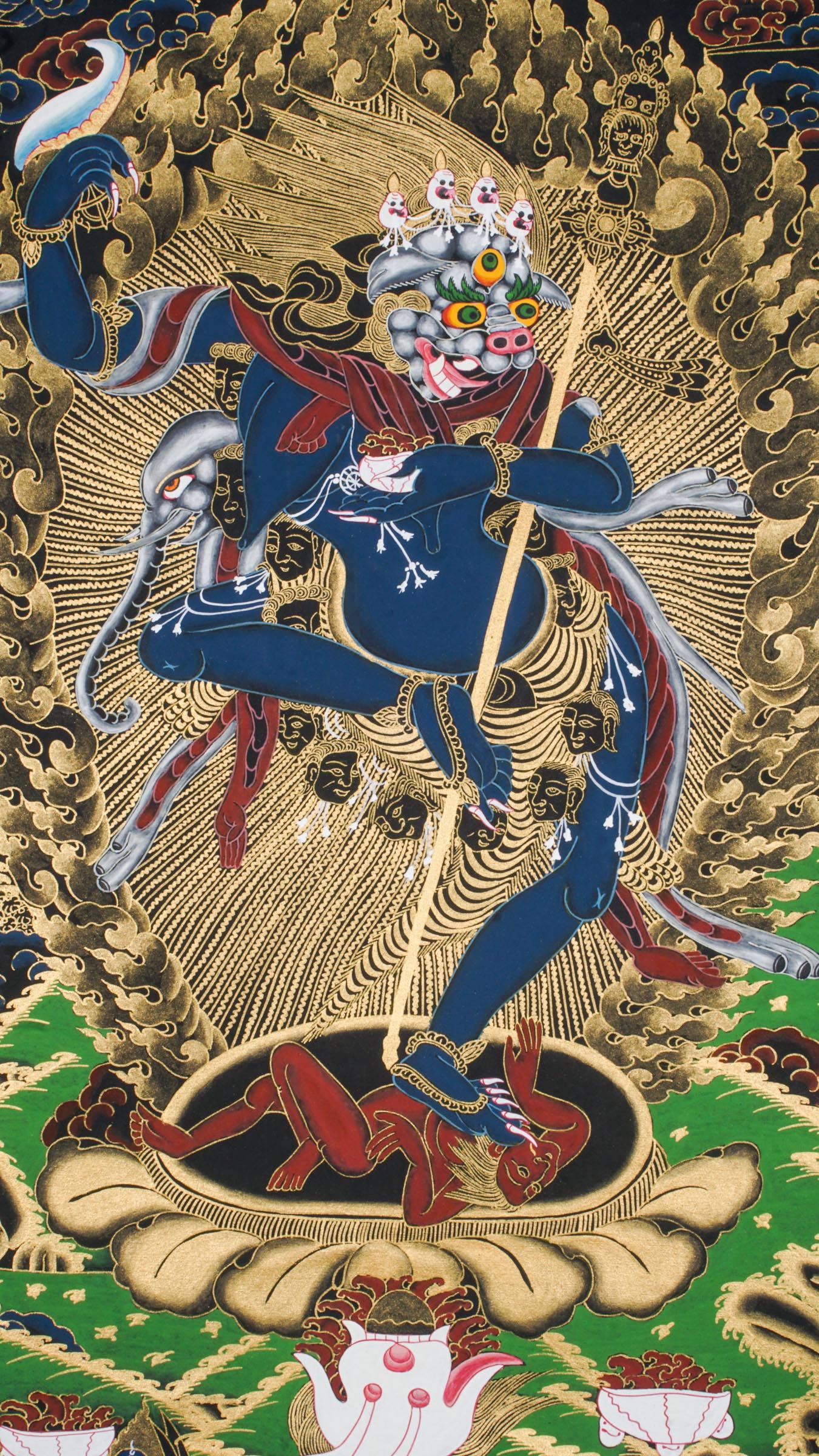 Traditional Tibetan thangka painting depicting Singh Mukhi, the lion-faced protector dakini, shown in a dynamic dancing pose on a lotus base, surrounded by radiant gold flames and intricate symbolic patterns on a dark background.