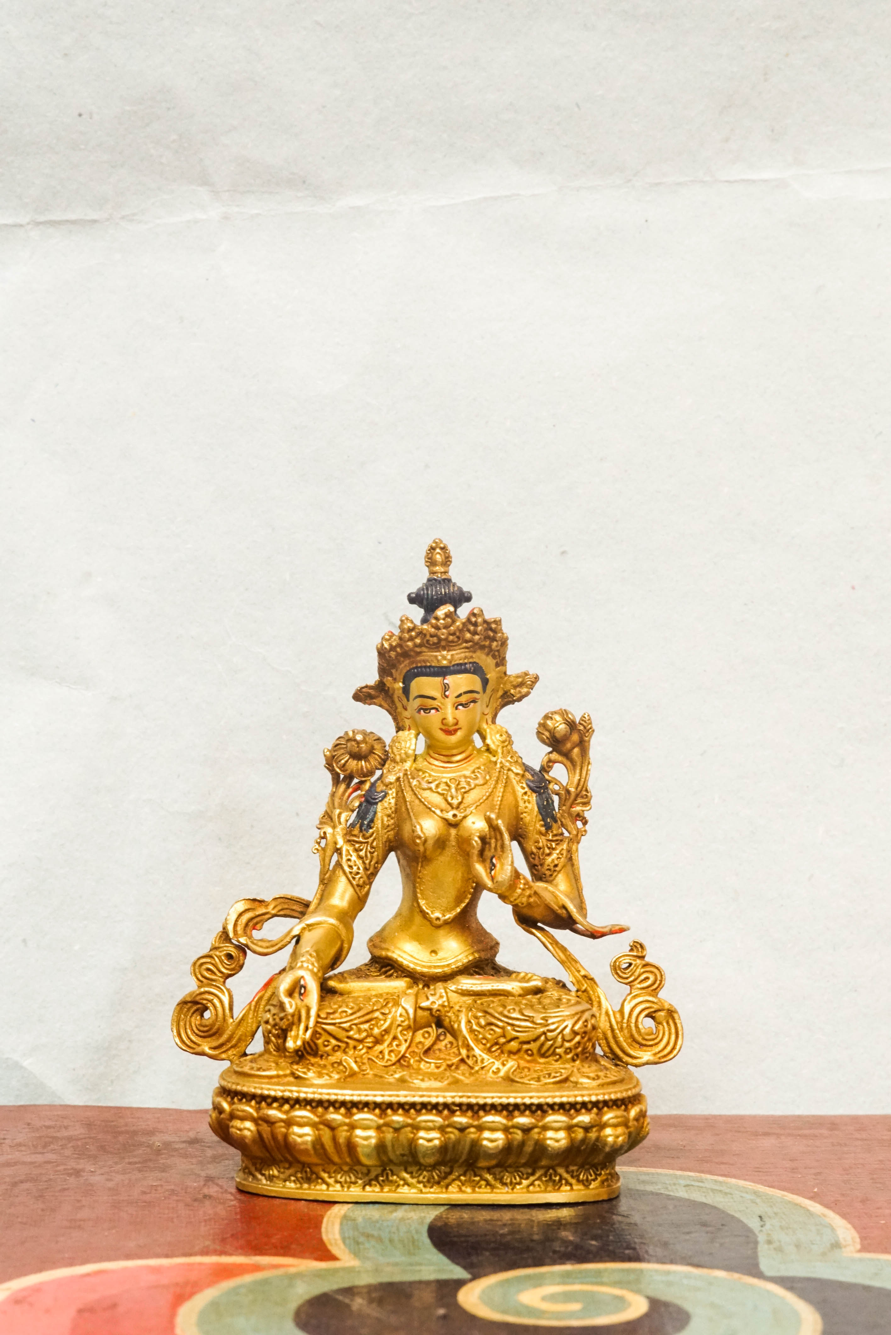 Gold-plated White Tara statue, depicting the compassionate goddess with calm expression and symbolic seven eyes.