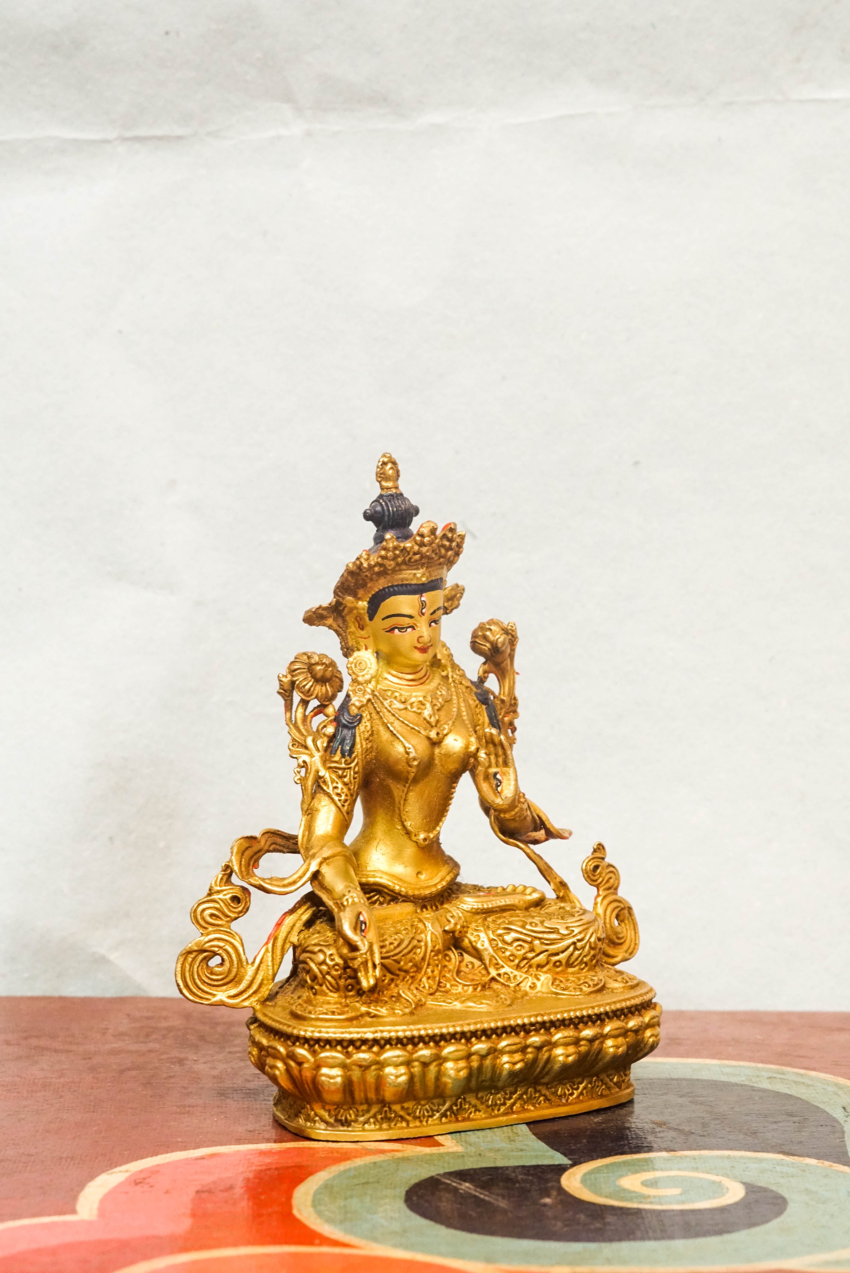 Gold-plated White Tara statue, depicting the compassionate goddess with calm expression and symbolic seven eyes.