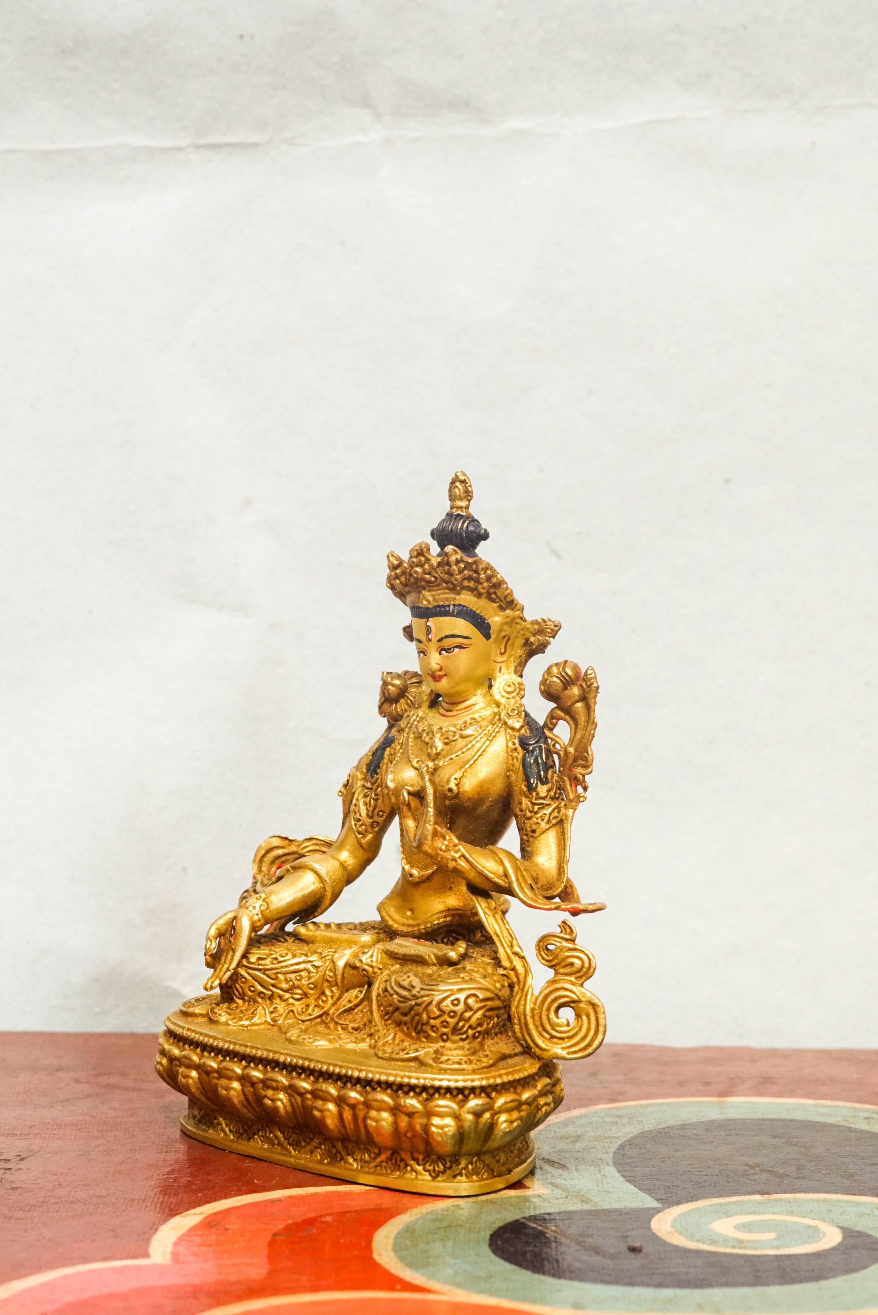 Gold-plated White Tara statue, depicting the compassionate goddess with calm expression and symbolic seven eyes.