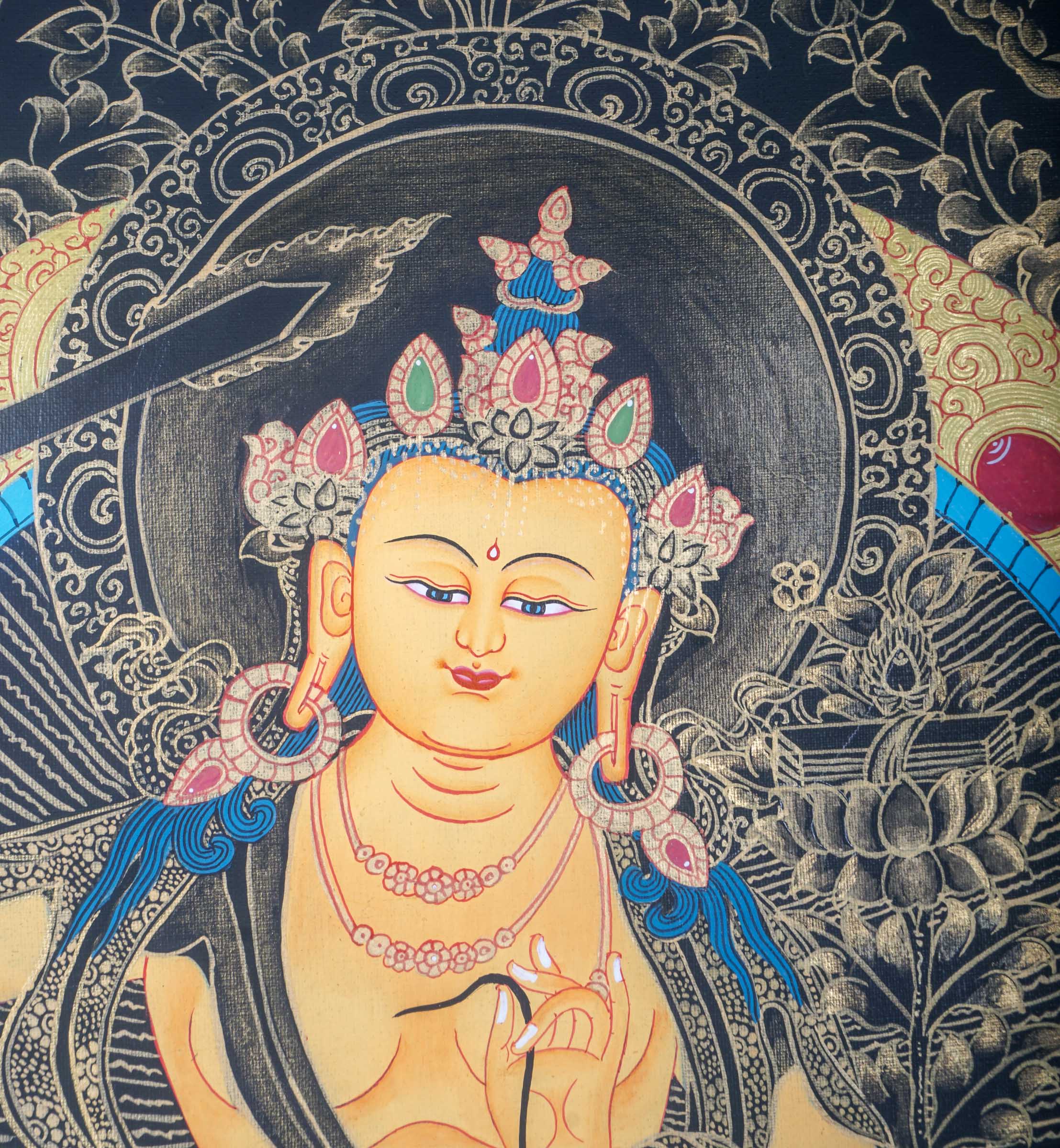 This genuine Tibetan Thangka of Manjushri depicts the Bodhisattva of wisdom with a sword and book, symbolizing the power to cut through ignorance and reveal enlightened knowledge. A sacred Buddhist painting, it is hand-painted with natural pigments, perfect for meditation and spiritual growth.