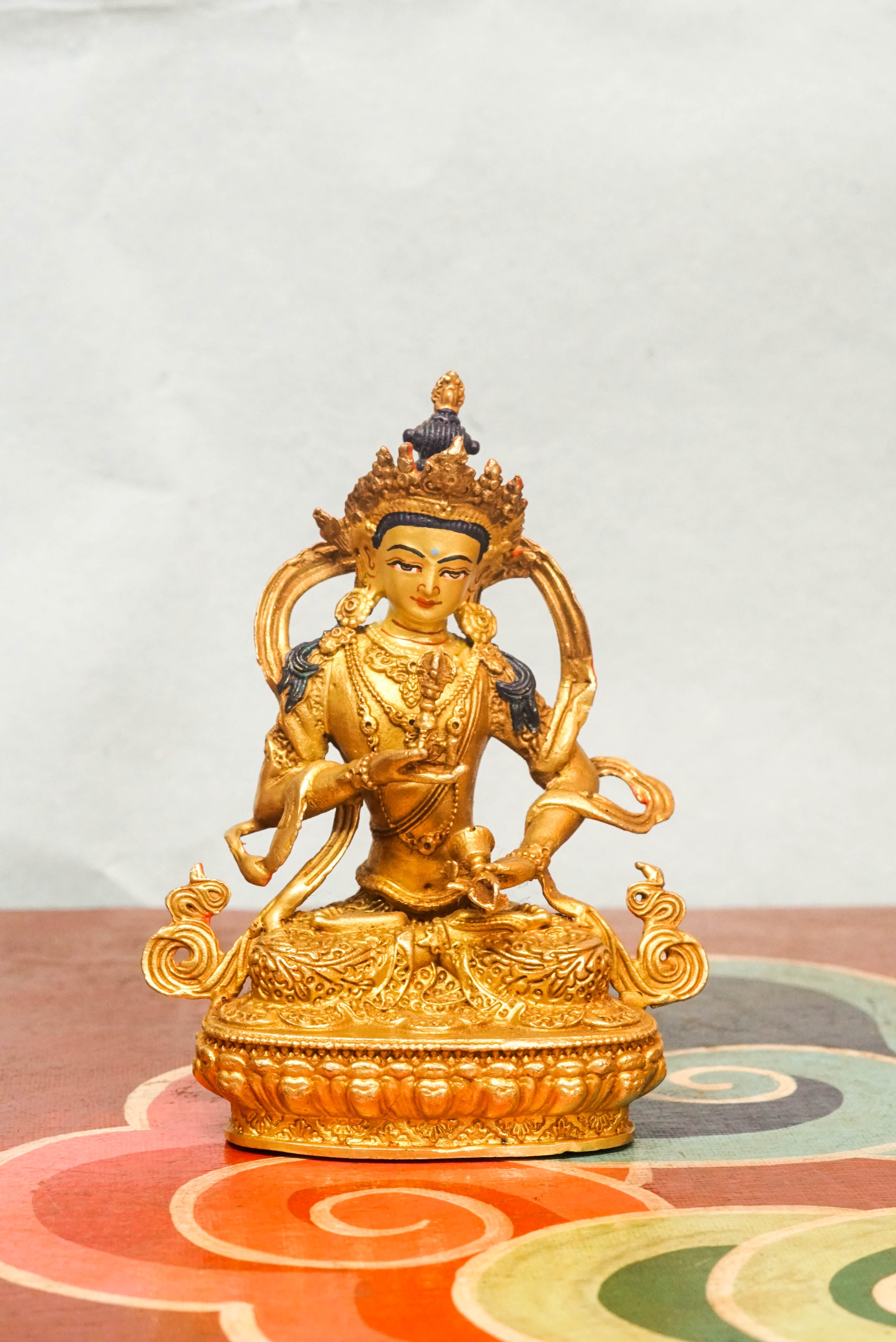 Handcrafted Vajrasattva statue seated in lotus posture, holding a vajra and bell, symbolizing spiritual purity, compassion, and wisdom in Vajrayana Buddhism.