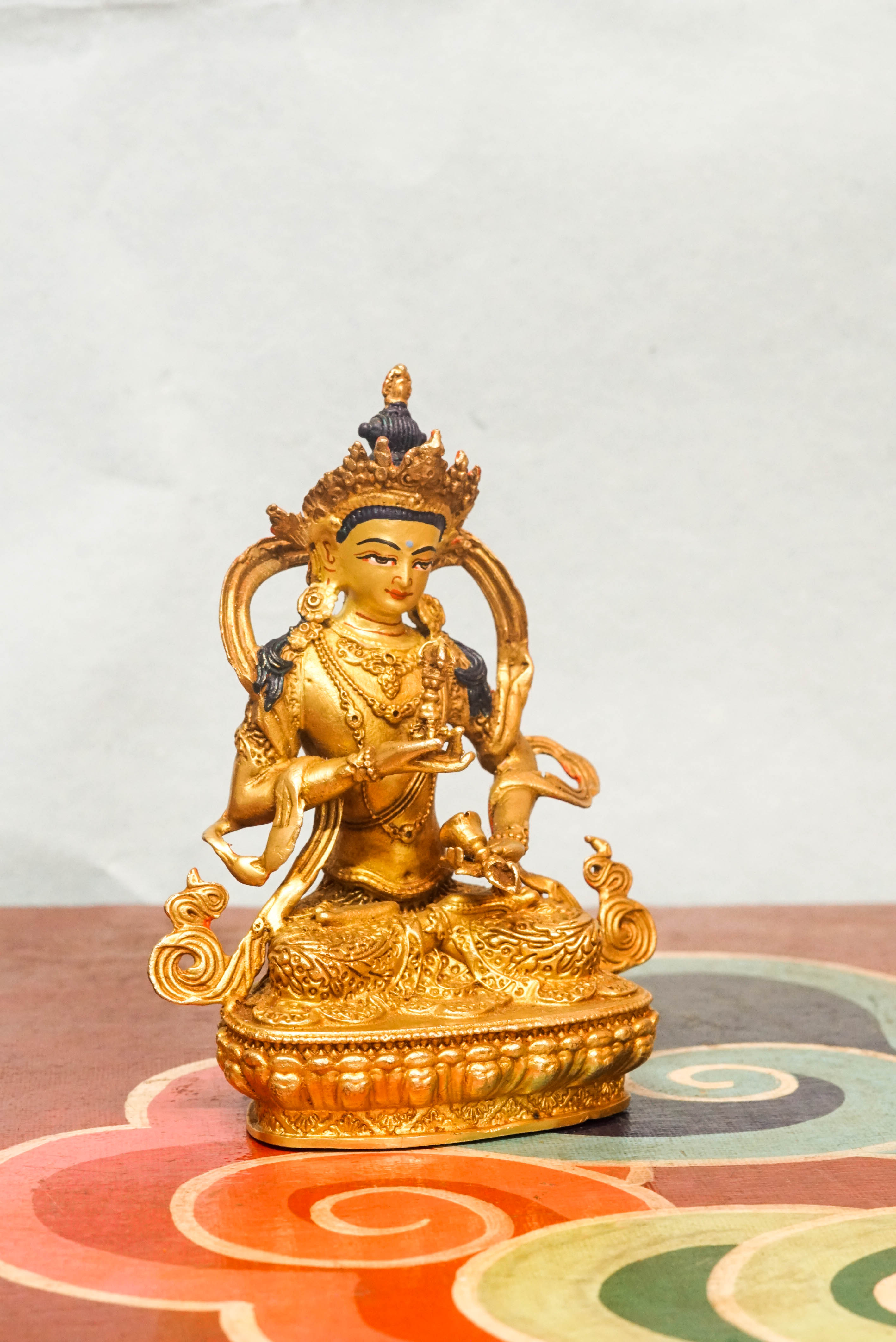 Handcrafted Vajrasattva statue seated in lotus posture, holding a vajra and bell, symbolizing spiritual purity, compassion, and wisdom in Vajrayana Buddhism.