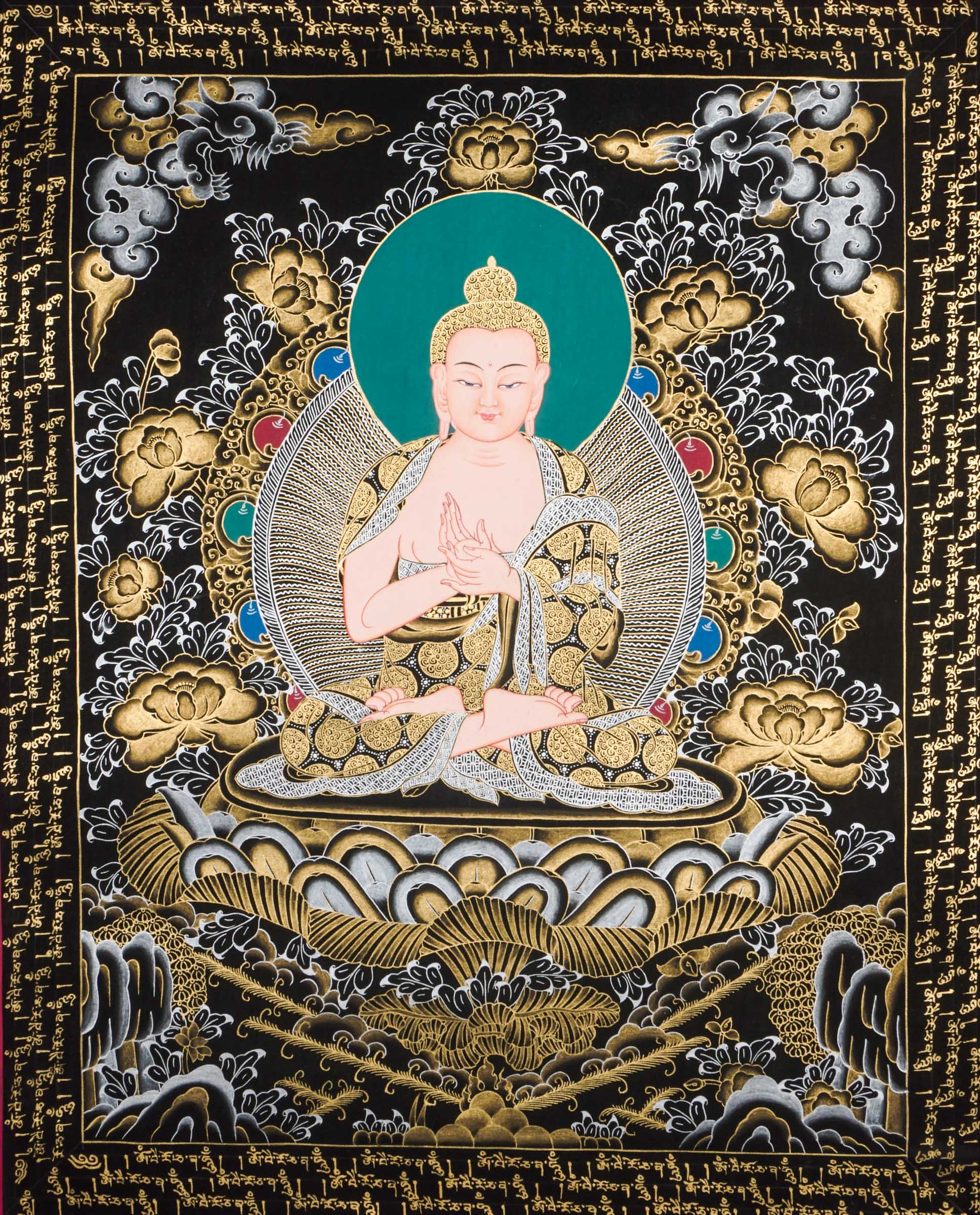 Traditional Tibetan thangka painting depicting White Buddha seated in meditation on a lotus throne, with hands in a teaching gesture, surrounded by intricate gold floral motifs on a black background and framed by sacred script.