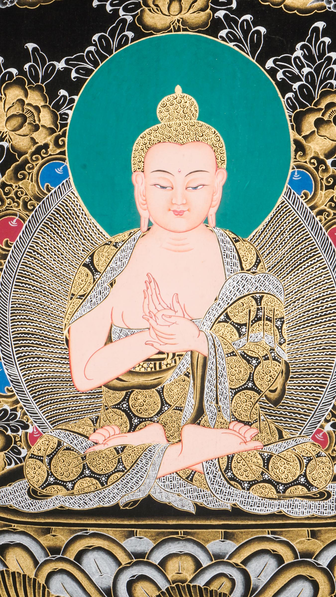 Traditional Tibetan thangka painting depicting White Buddha seated in meditation on a lotus throne, with hands in a teaching gesture, surrounded by intricate gold floral motifs on a black background and framed by sacred script.