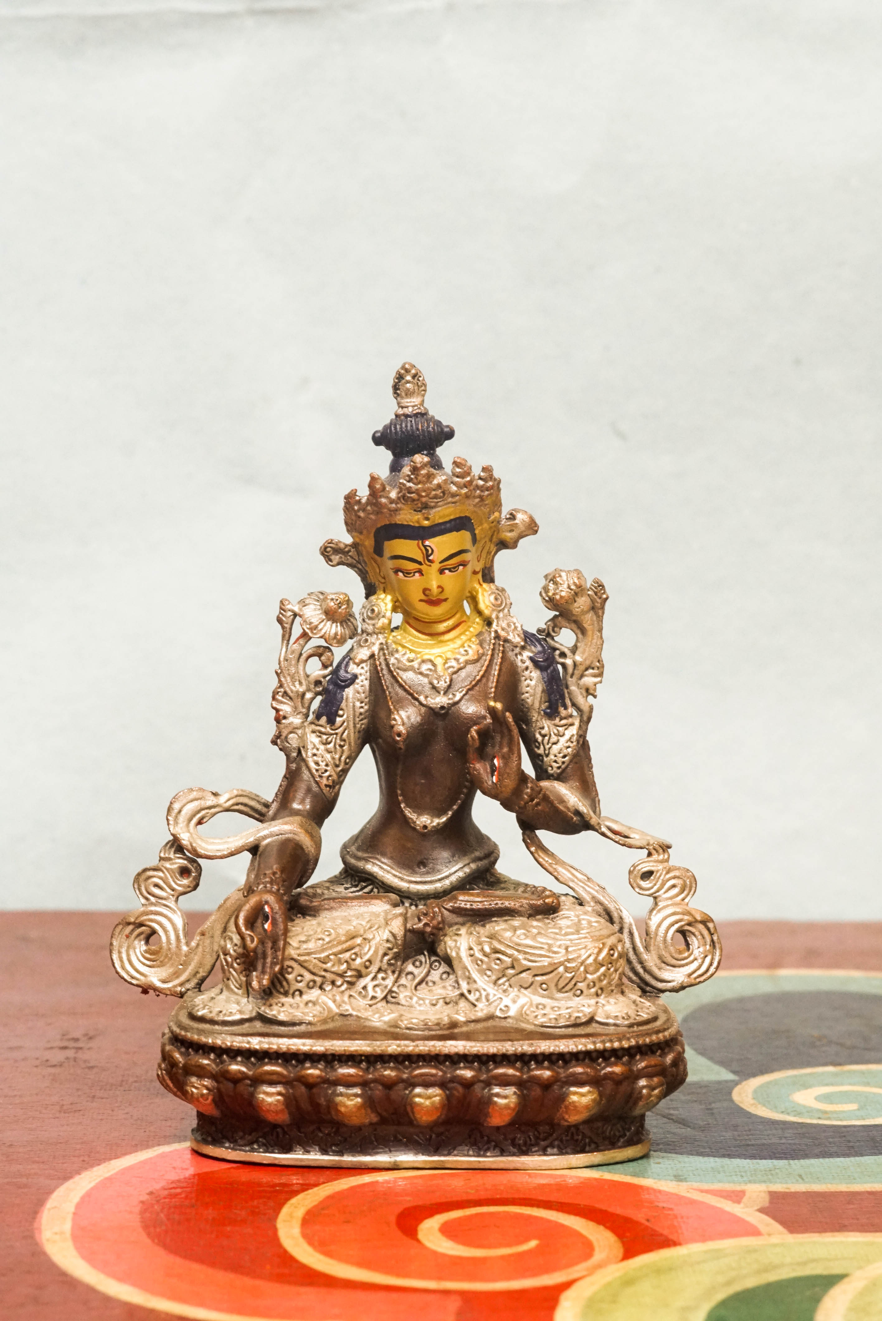 Handmade silver White Tara statue, depicting the compassionate goddess with calm expression and symbolic seven eyes.