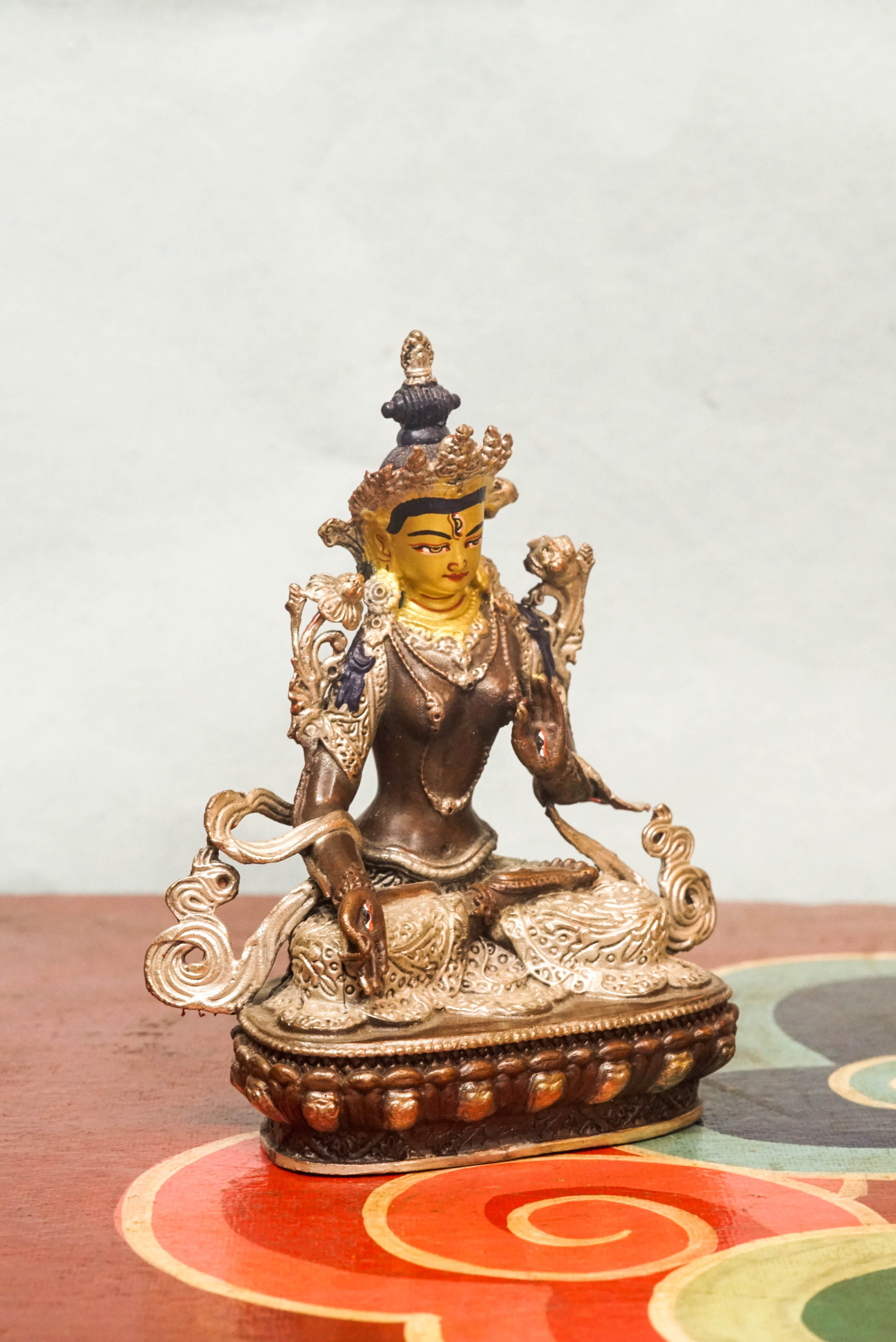 Handmade silver White Tara statue, depicting the compassionate goddess with calm expression and symbolic seven eyes.