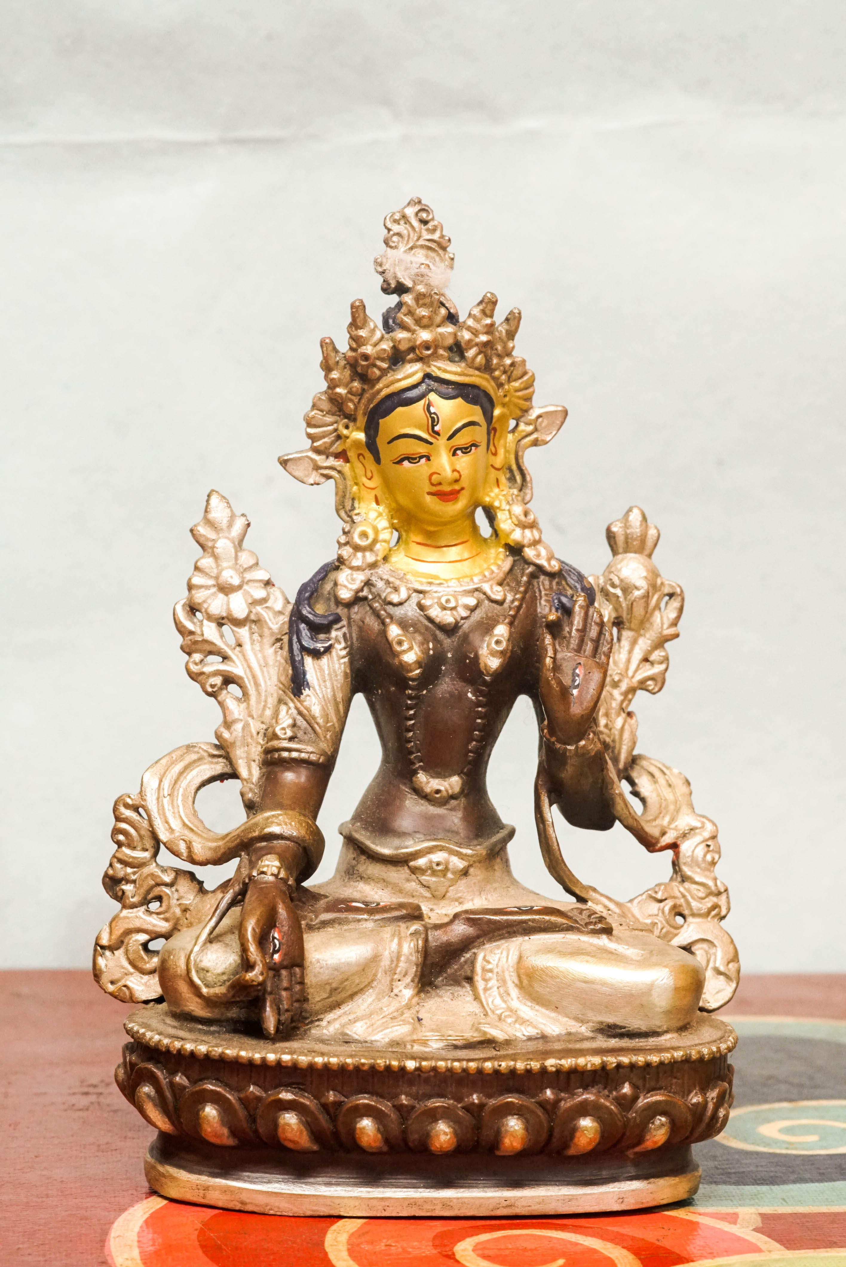 Detailed statue of White Tara, Tibetan Buddhist Bodhisattva of compassion and longevity, featuring seven eyes and traditional robes.