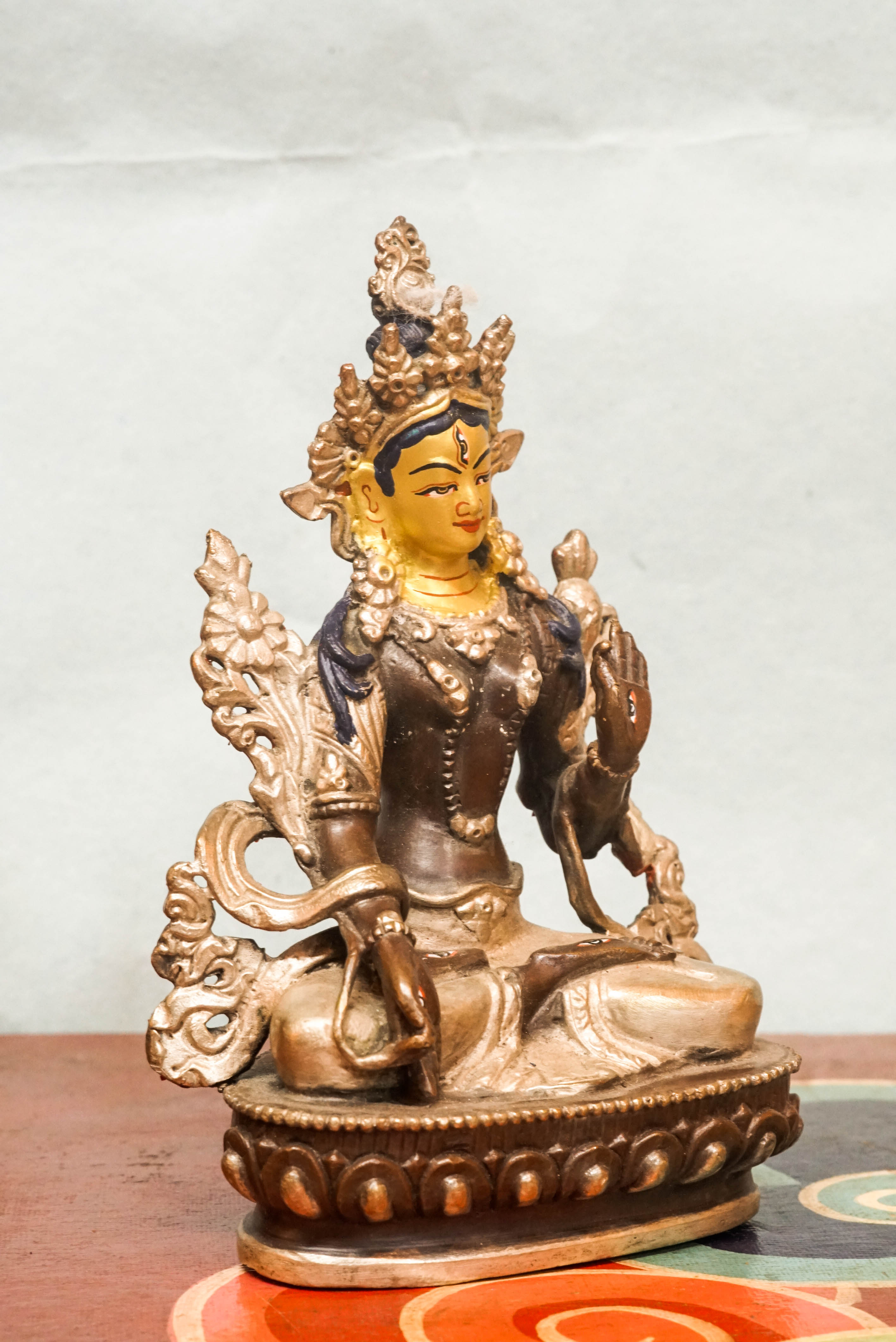 Detailed statue of White Tara, Tibetan Buddhist Bodhisattva of compassion and longevity, featuring seven eyes and traditional robes.