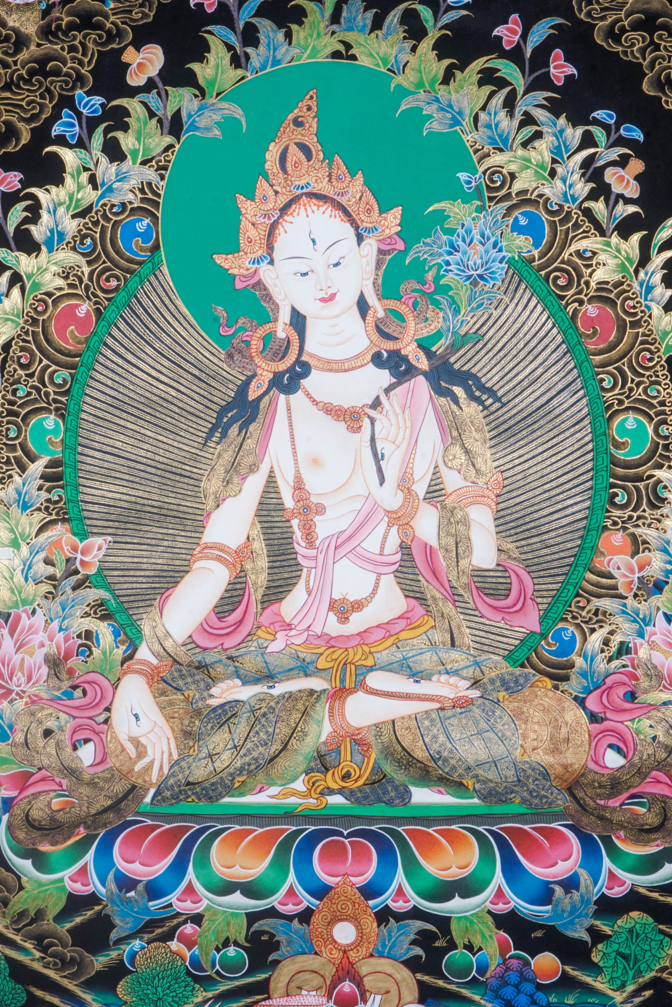 The White Tara Thangka Painting symbolizes healing, compassion, and long life, featuring the goddess with seven eyes and hand-painted using natural pigments by Tibetan artisans—perfect for spiritual growth and protection.