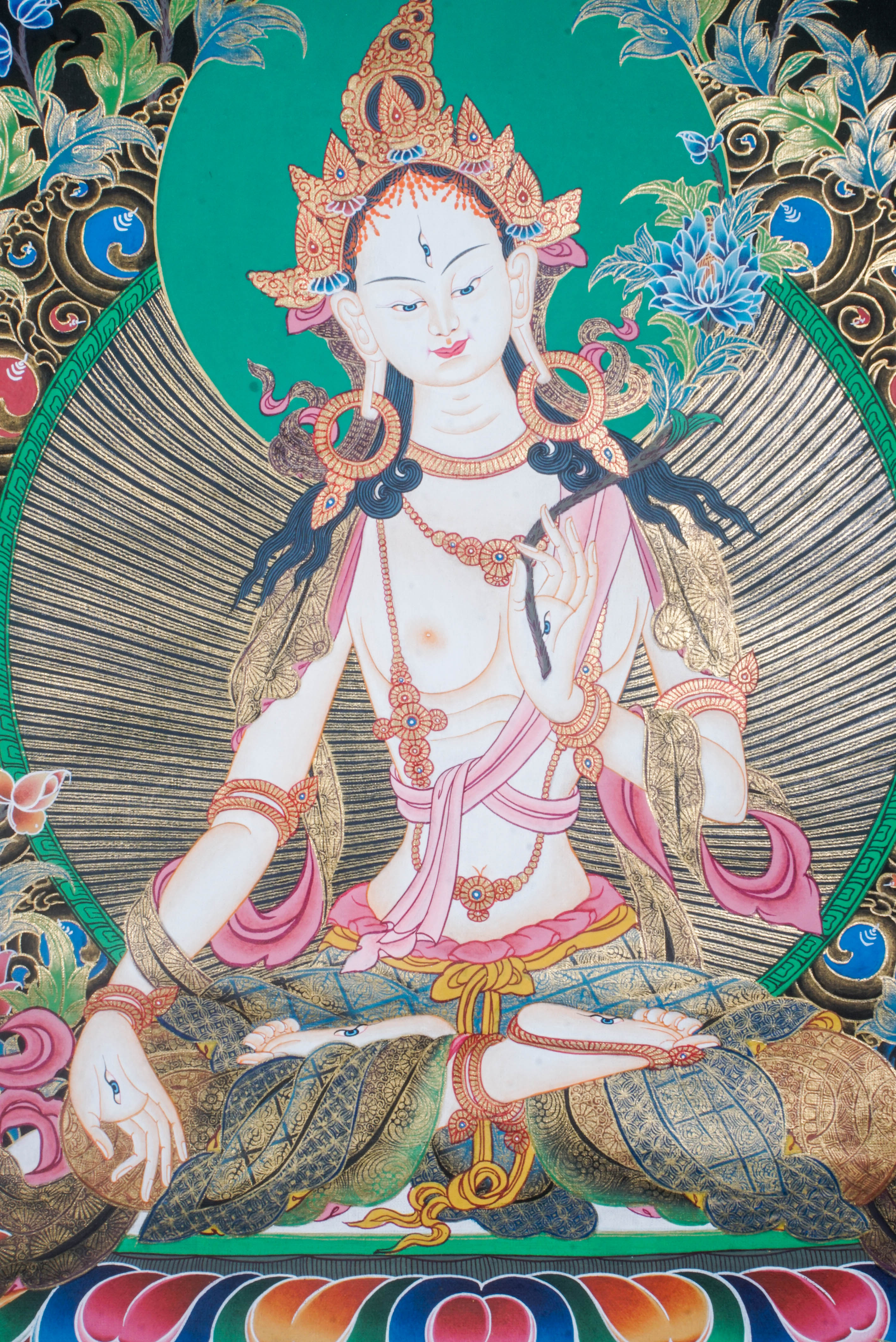 The White Tara Thangka Painting symbolizes healing, compassion, and long life, featuring the goddess with seven eyes and hand-painted using natural pigments by Tibetan artisans—perfect for spiritual growth and protection.