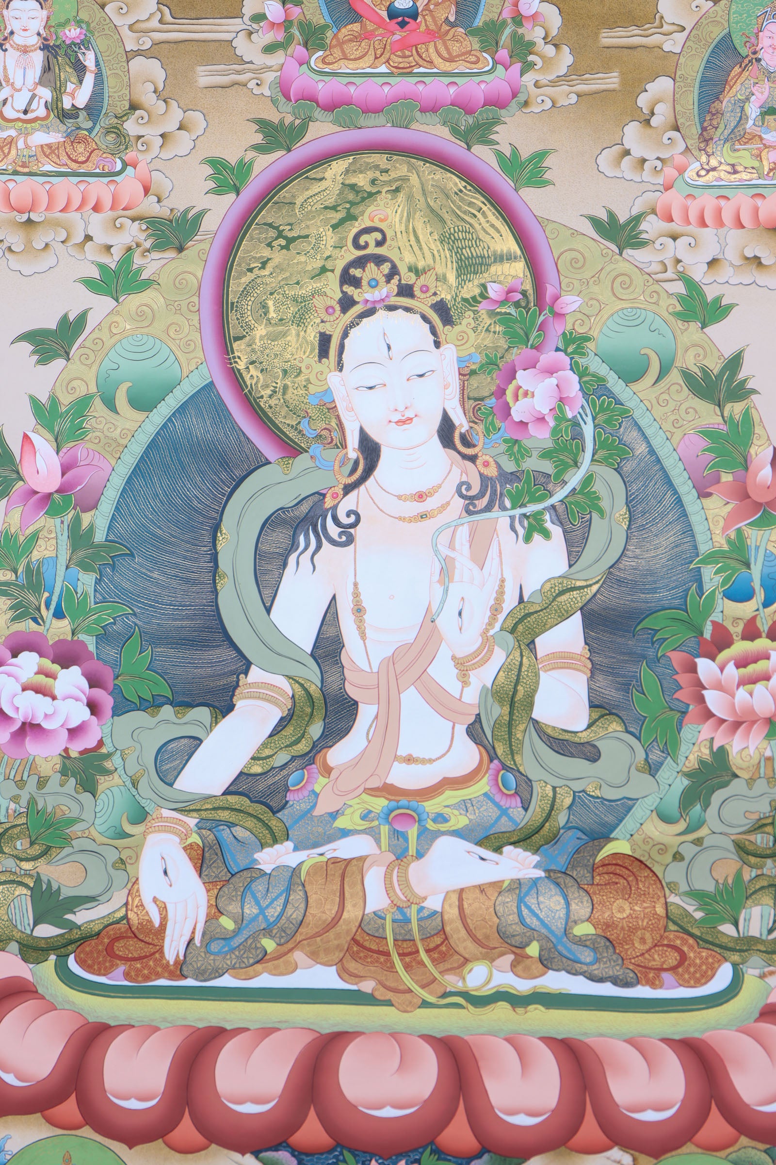 This genuine White Tara Thangka is a captivating piece of Tibetan art symbolizing compassion, purity, and healing. Hand-painted by skilled artisans using all-natural mineral pigments, it features White Tara seated in serene grace with seven vigilant eyes, offering blessings of peace, longevity, and spiritual protection.