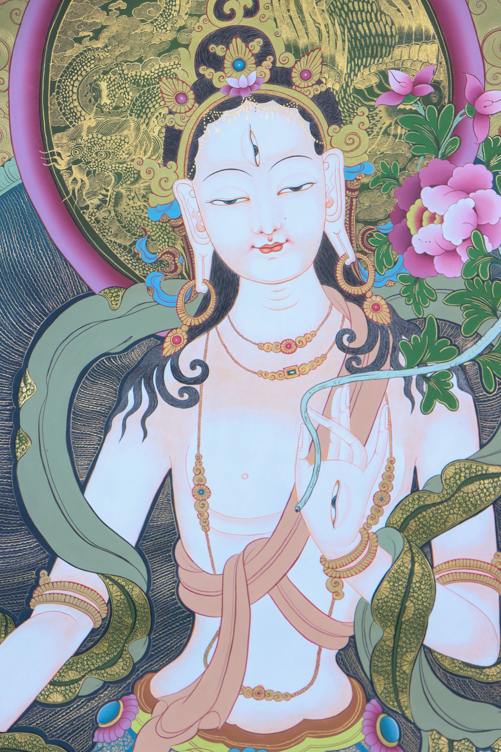 This genuine White Tara Thangka is a captivating piece of Tibetan art symbolizing compassion, purity, and healing. Hand-painted by skilled artisans using all-natural mineral pigments, it features White Tara seated in serene grace with seven vigilant eyes, offering blessings of peace, longevity, and spiritual protection.
