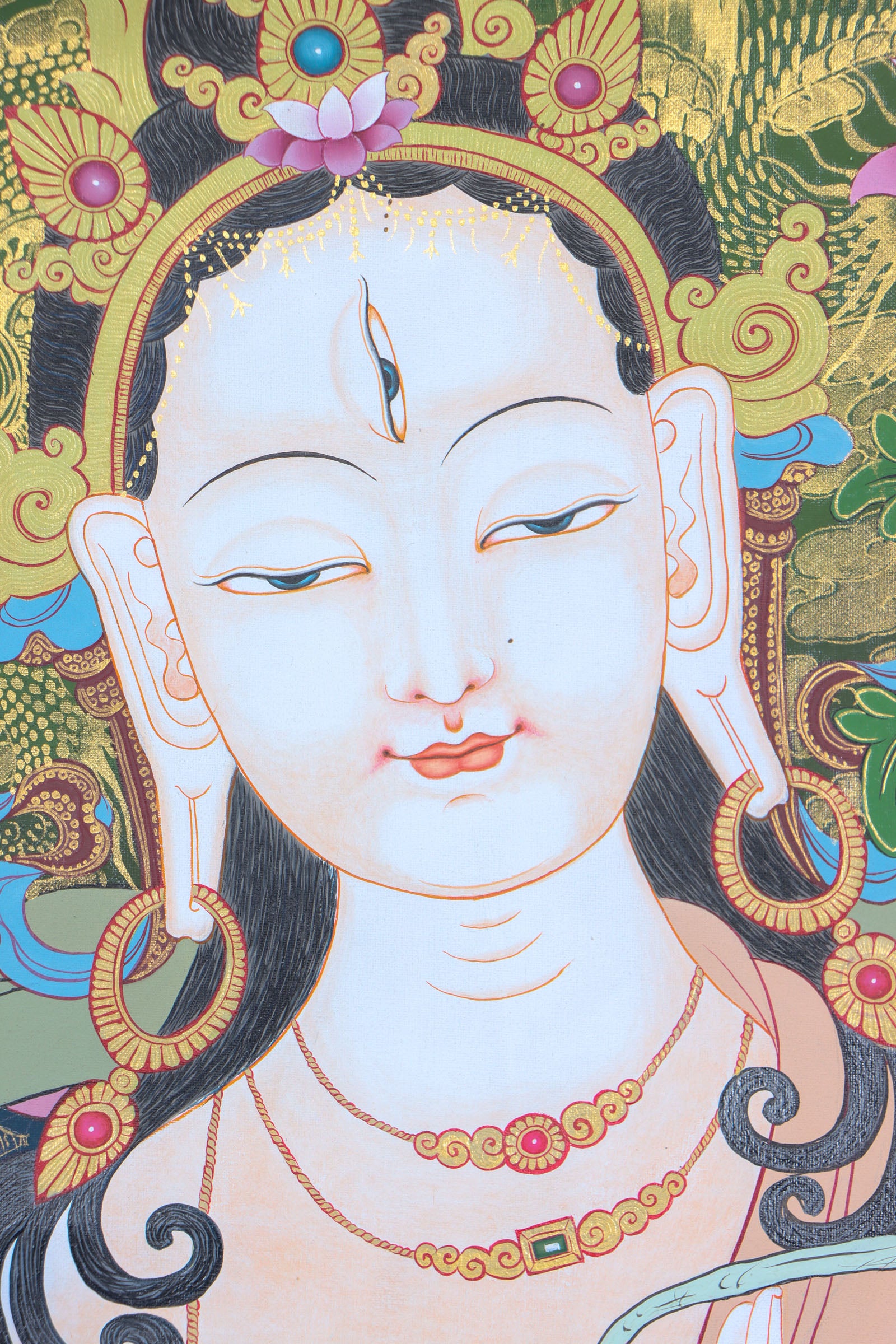 This genuine White Tara Thangka is a captivating piece of Tibetan art symbolizing compassion, purity, and healing. Hand-painted by skilled artisans using all-natural mineral pigments, it features White Tara seated in serene grace with seven vigilant eyes, offering blessings of peace, longevity, and spiritual protection.