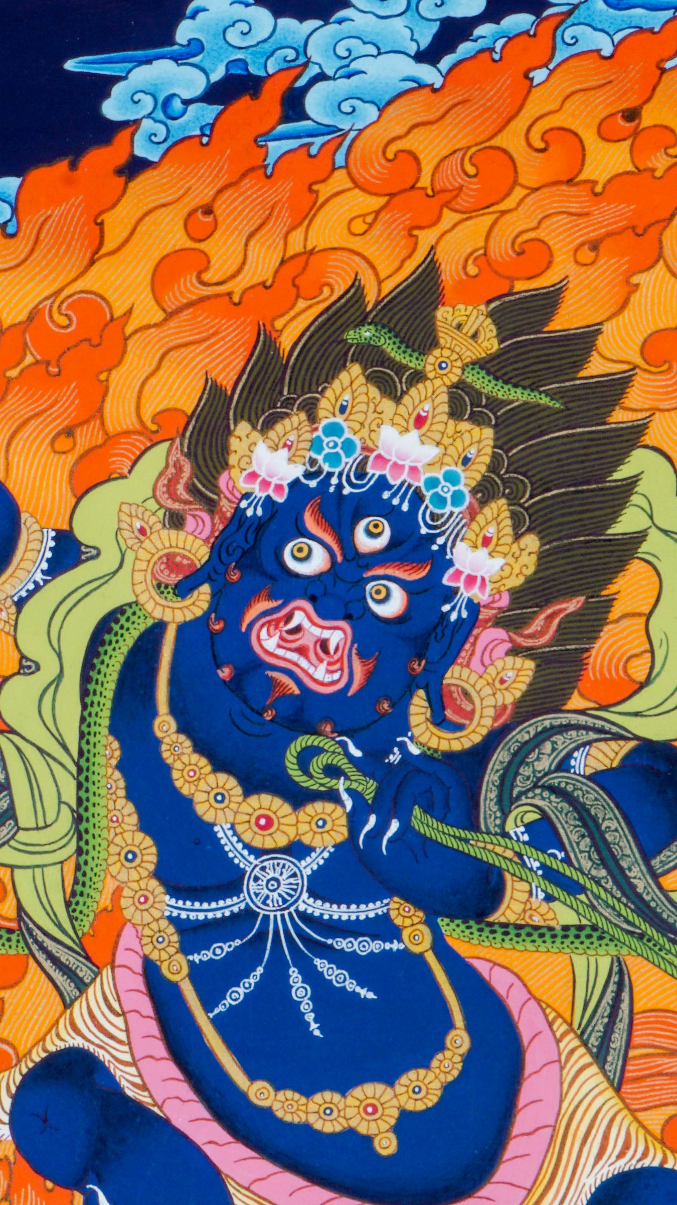 Traditional Tibetan thangka painting depicting wrathful Vajrapani, a blue-skinned deity in a powerful dynamic pose on a lotus throne, surrounded by blazing flames, clouds, and ornate symbolic details against a deep blue background.