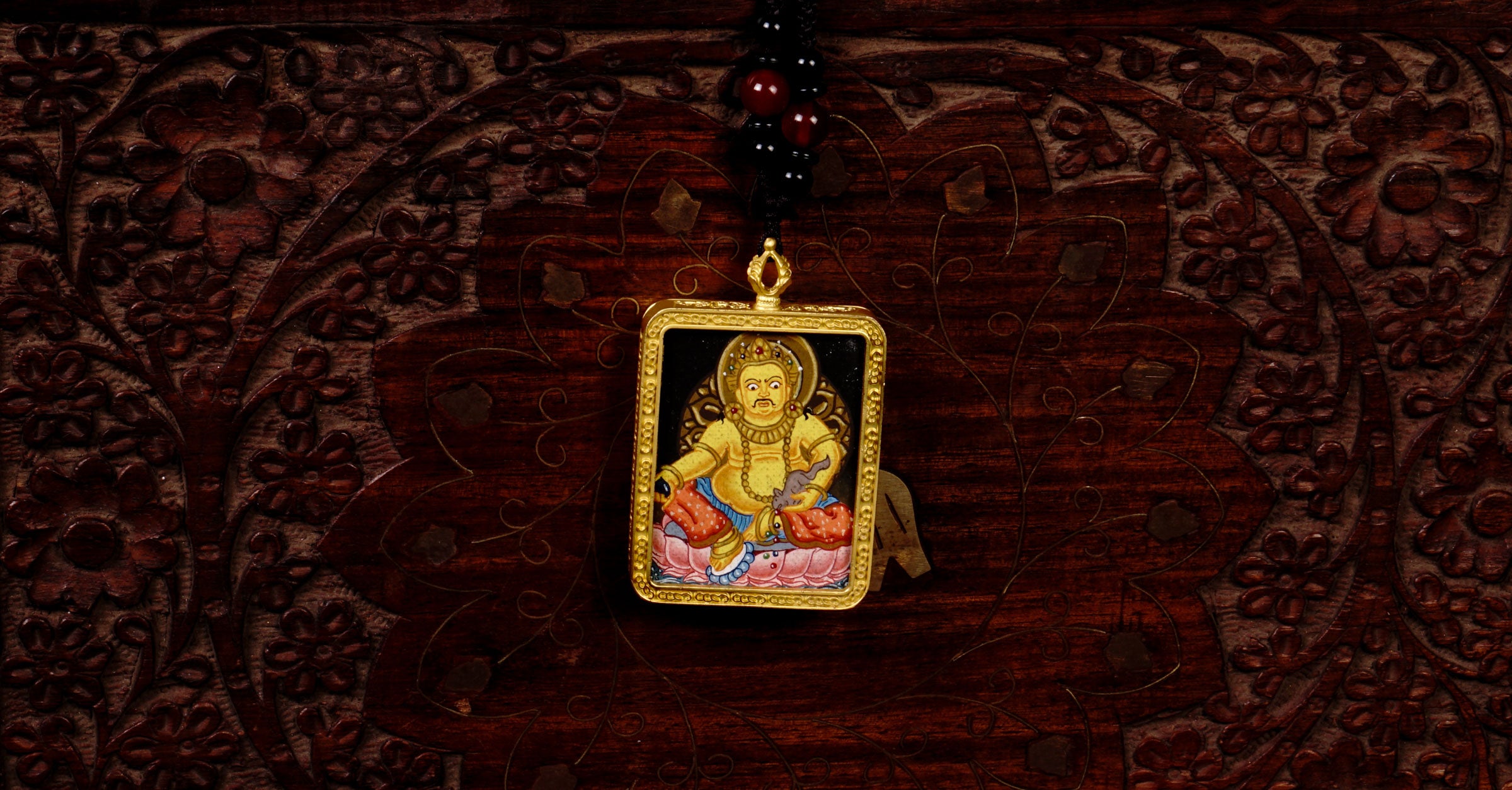Hand-painted Yellow Zambala miniature Thangka pendant in gold-accented copper Ghau locket with black beaded cord.