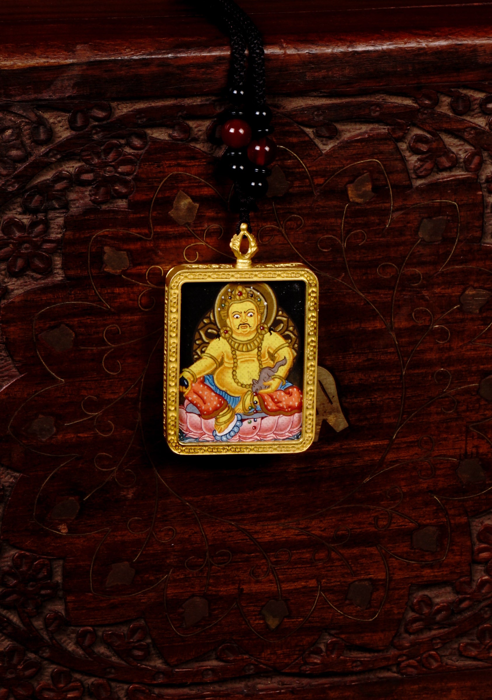 Hand-painted Yellow Zambala miniature Thangka pendant in gold-accented copper Ghau locket with black beaded cord.