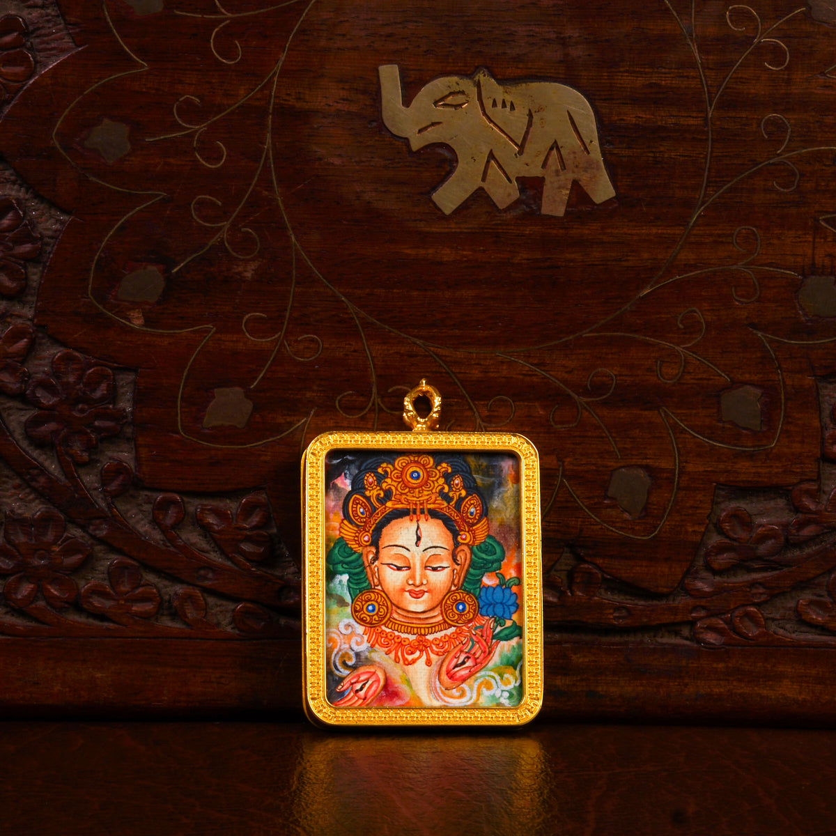 Newari White Tara Ghau pendant featuring a miniature Tibetan Buddhist goddess artwork in a decorative gold-tone frame handcrafted in Nepal.