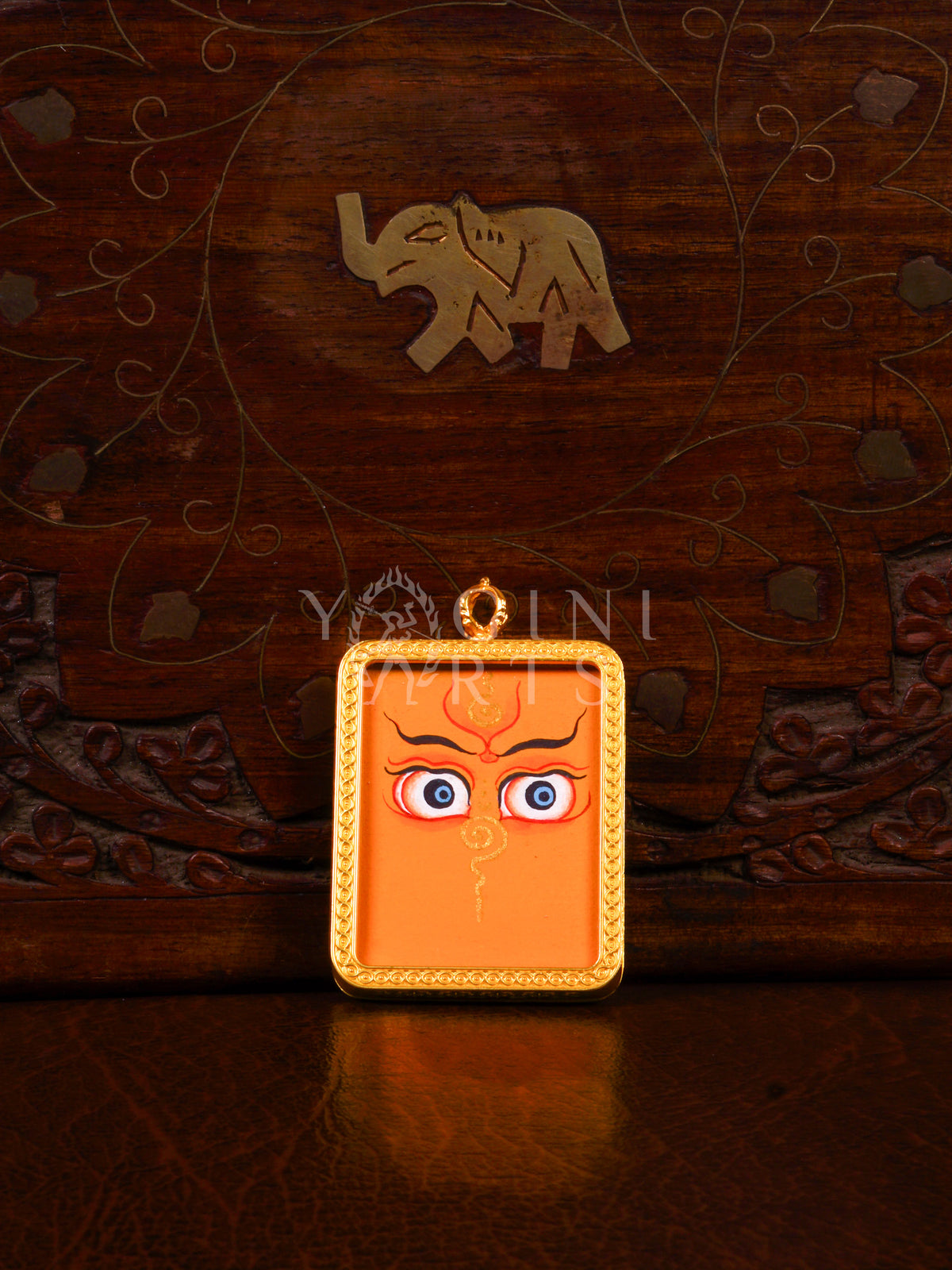Hand-painted Zambhala Eyes Ghau pendant with sacred Buddha Wisdom Eyes in a handcrafted gold-tone frame made in Nepal.