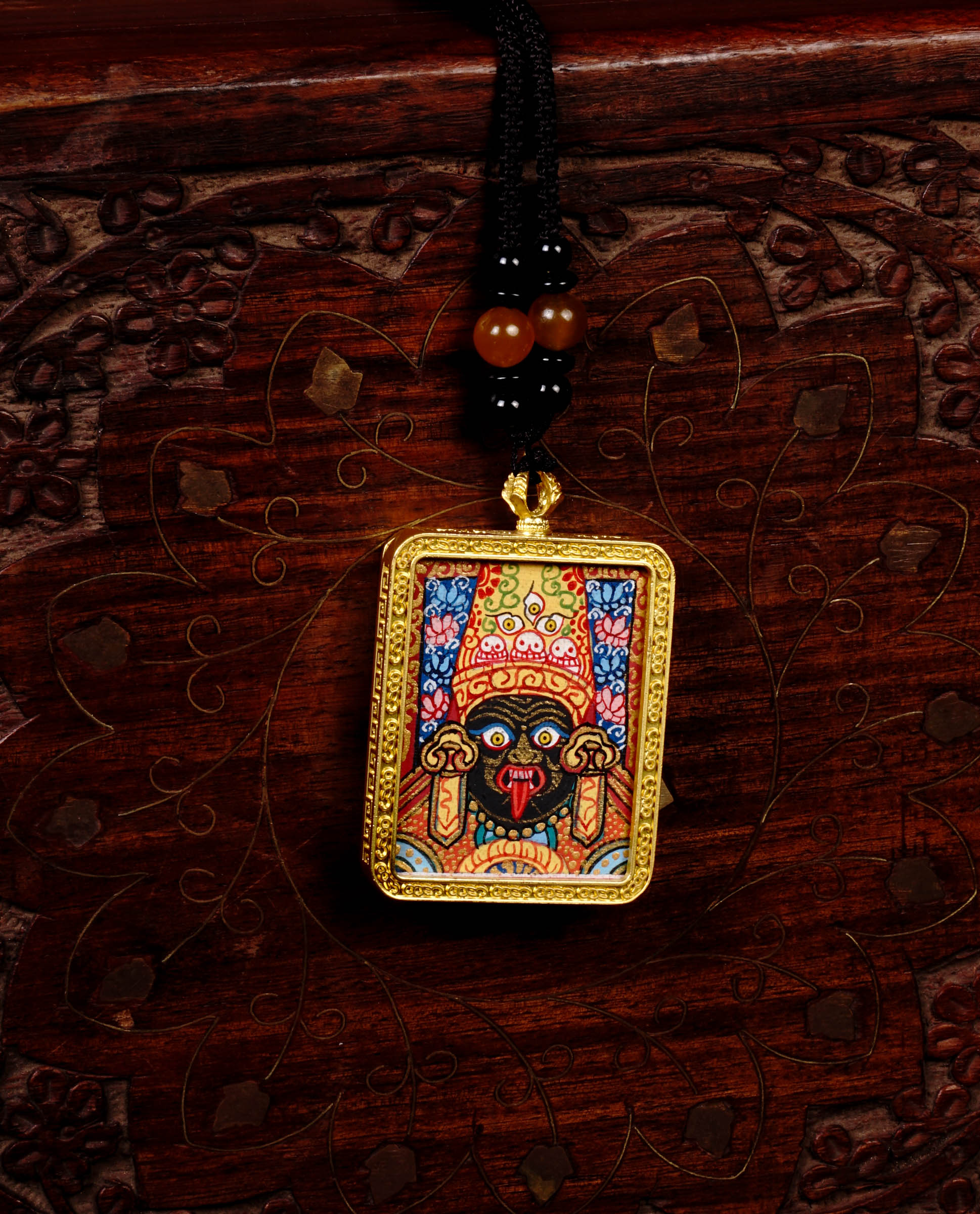 Hand-painted Goddess Kali miniature Thangka pendant in gold-accented copper Ghau locket with black beaded cord.