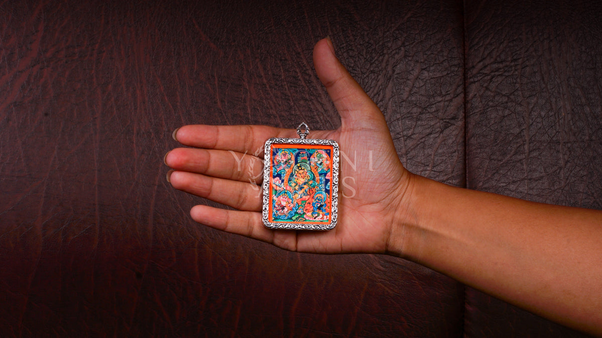 Hand-painted Five Zambhala Ghau pendant featuring the Five Buddhist Wealth Deities in a handcrafted silver-tone frame made in Nepal.