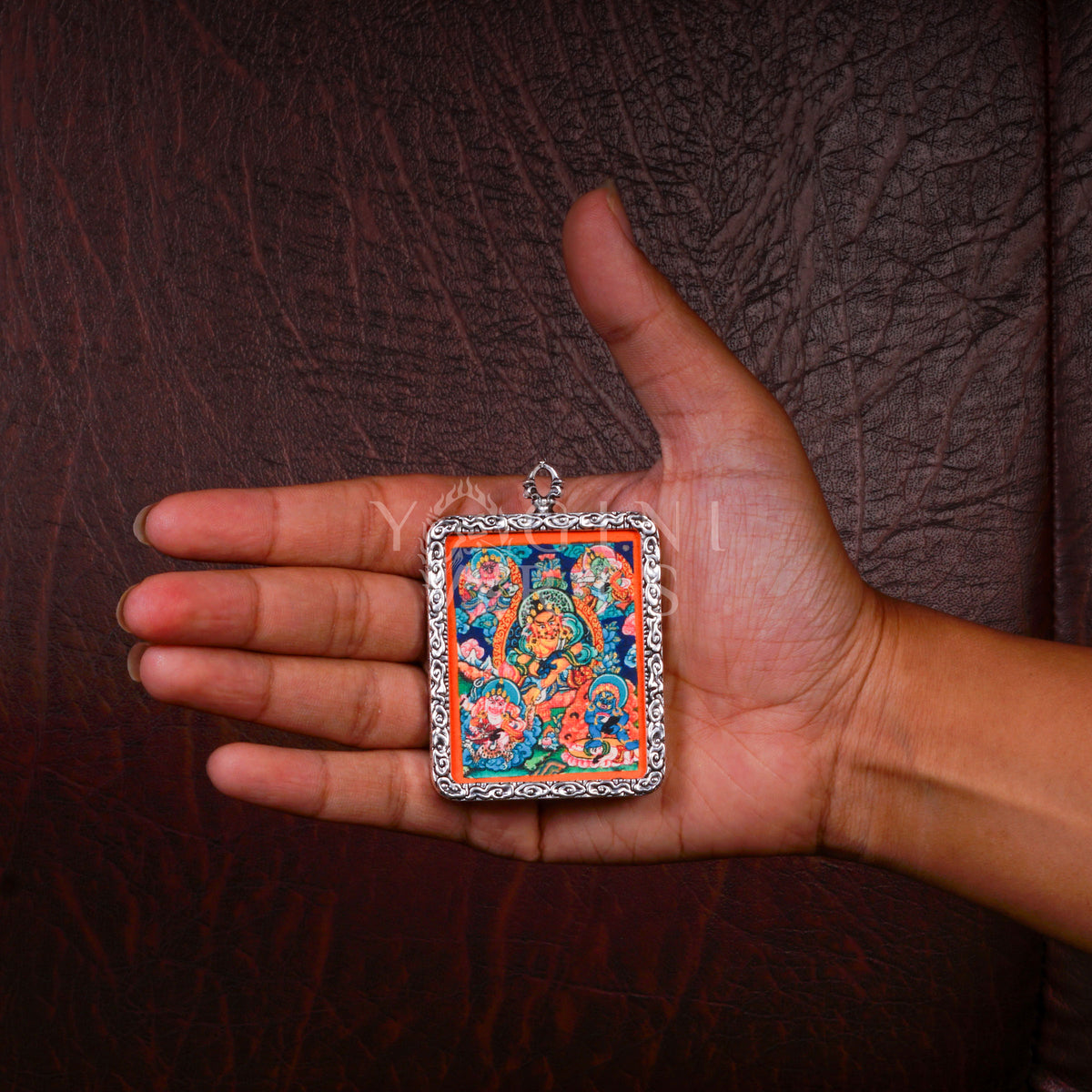 Hand-painted Five Zambhala Ghau pendant featuring the Five Buddhist Wealth Deities in a handcrafted silver-tone frame made in Nepal.