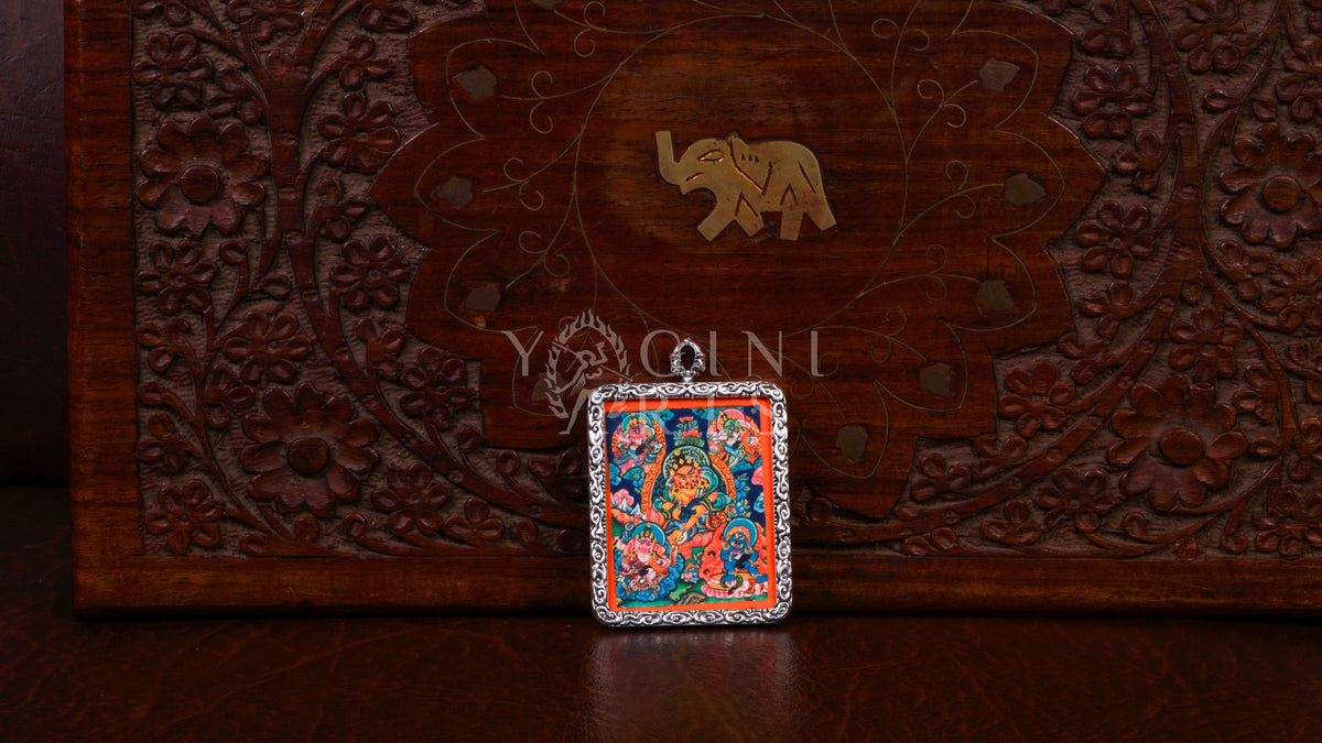 Hand-painted Five Zambhala Ghau pendant featuring the Five Buddhist Wealth Deities in a handcrafted silver-tone frame made in Nepal.