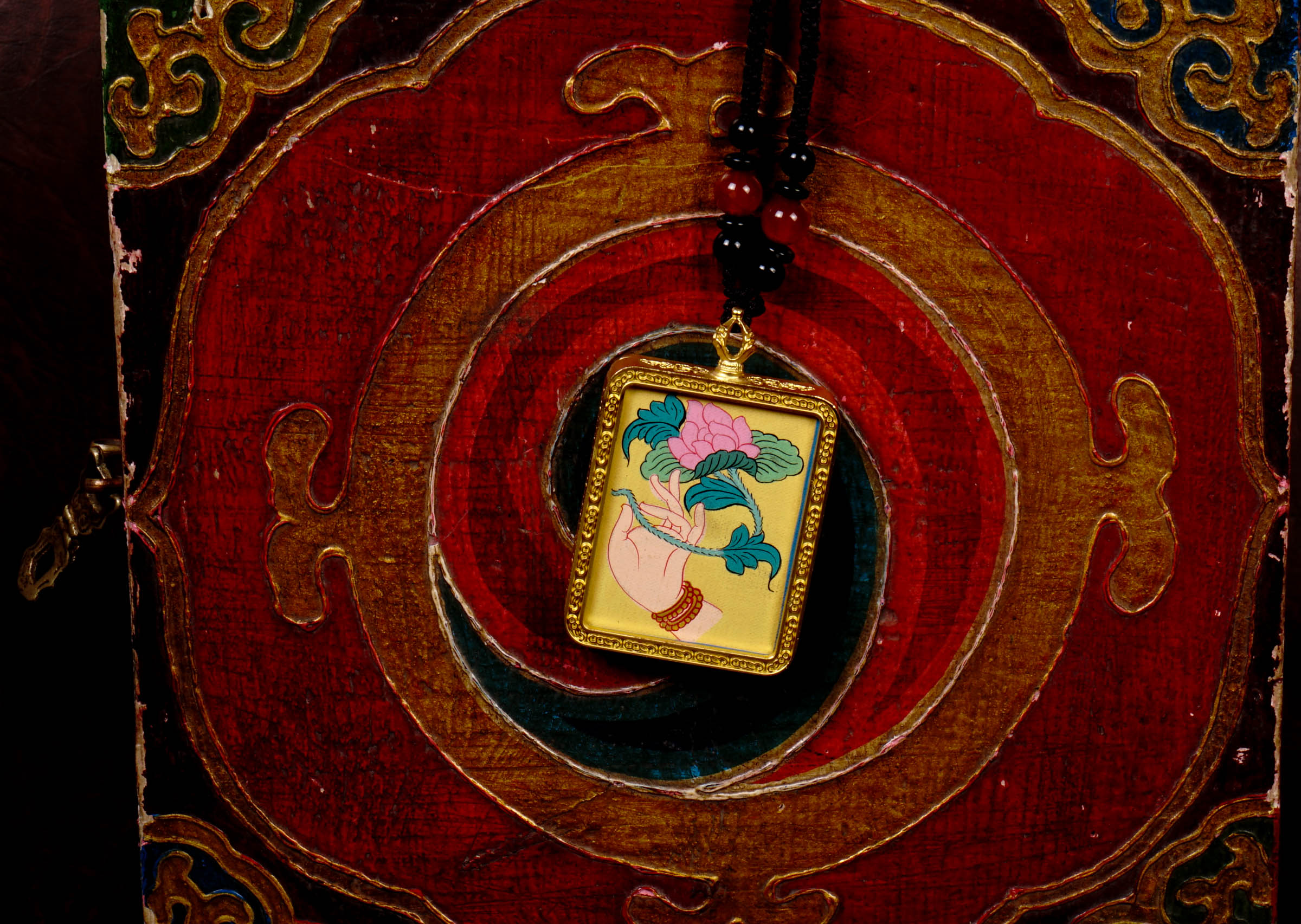 Hand-painted lotus flower in sacred hand miniature Thangka pendant inside gold-accented copper Ghau locket with black beaded cord.