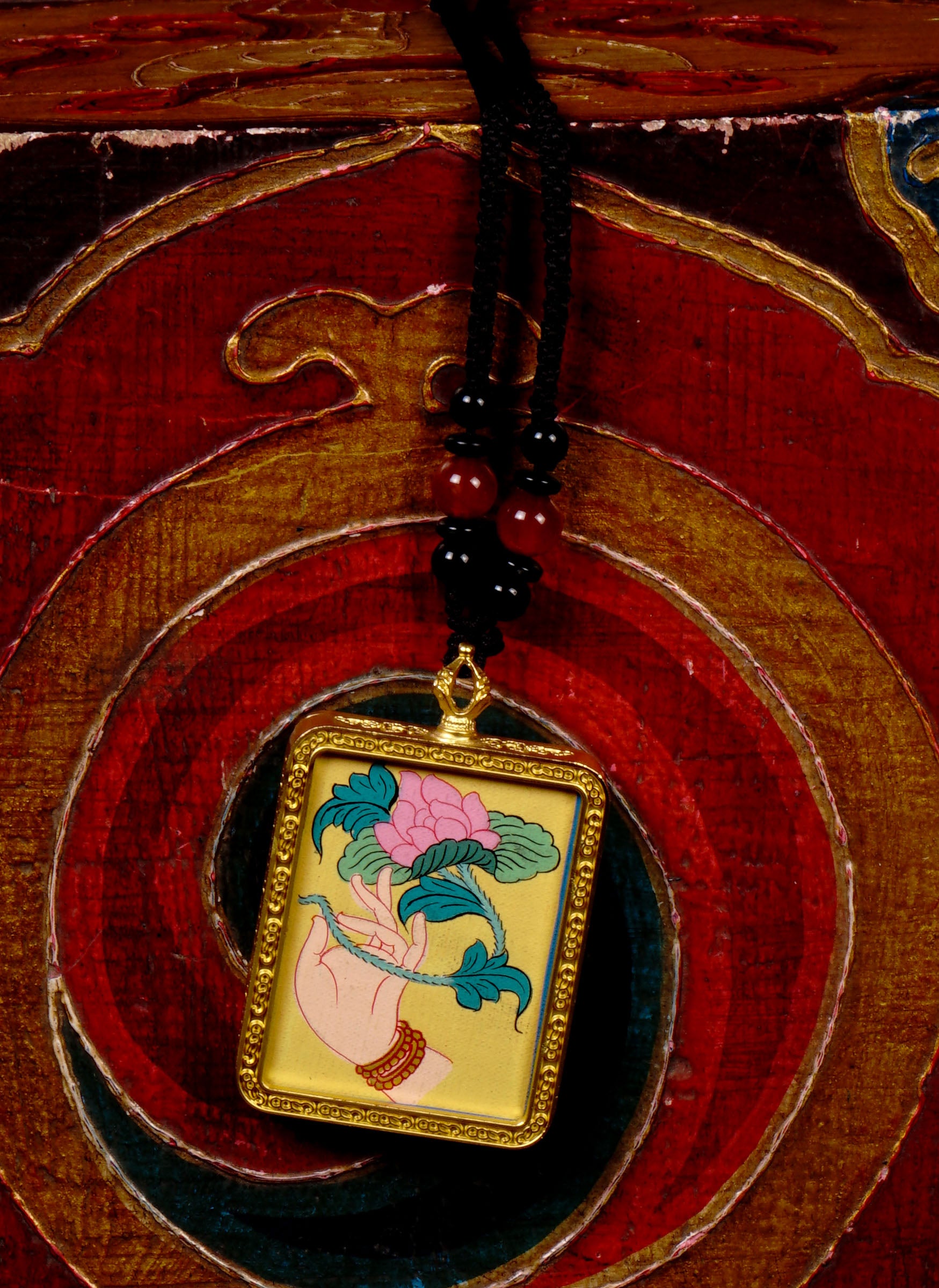 Hand-painted lotus flower in sacred hand miniature Thangka pendant inside gold-accented copper Ghau locket with black beaded cord.