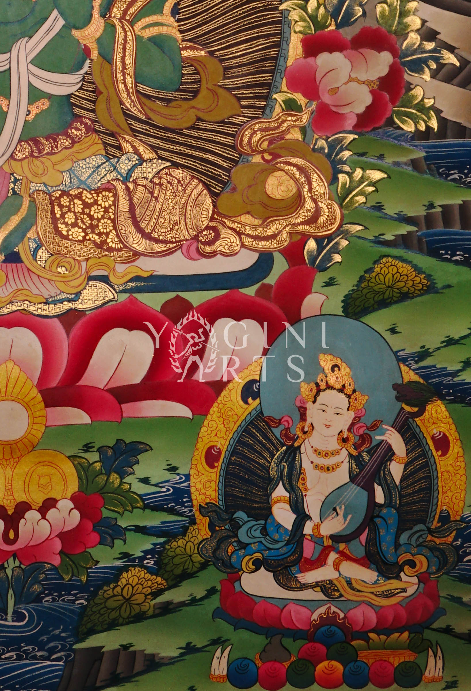 Green Tara thangka featuring the  Buddhist goddess of compassion seated on a lotus throne surrounded by vibrant sacred symbolism and gold detailing