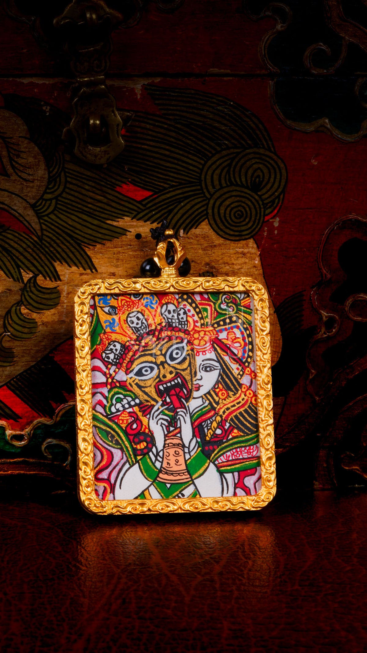 Hand-painted Zhaji Lhamo Ghau pendant in a gold-tone frame, handcrafted in Nepal using traditional Himalayan miniature painting techniques.