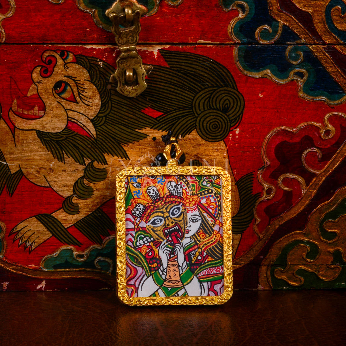 Hand-painted Zhaji Lhamo Ghau pendant in a gold-tone frame, handcrafted in Nepal using traditional Himalayan miniature painting techniques.