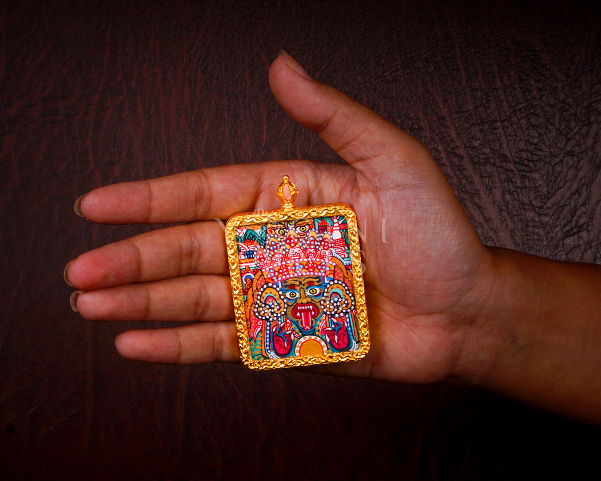 Hand-painted Zhaji Lhamo Ghau pendant in a gold-tone frame, handcrafted in Nepal using traditional Tibetan miniature painting techniques.